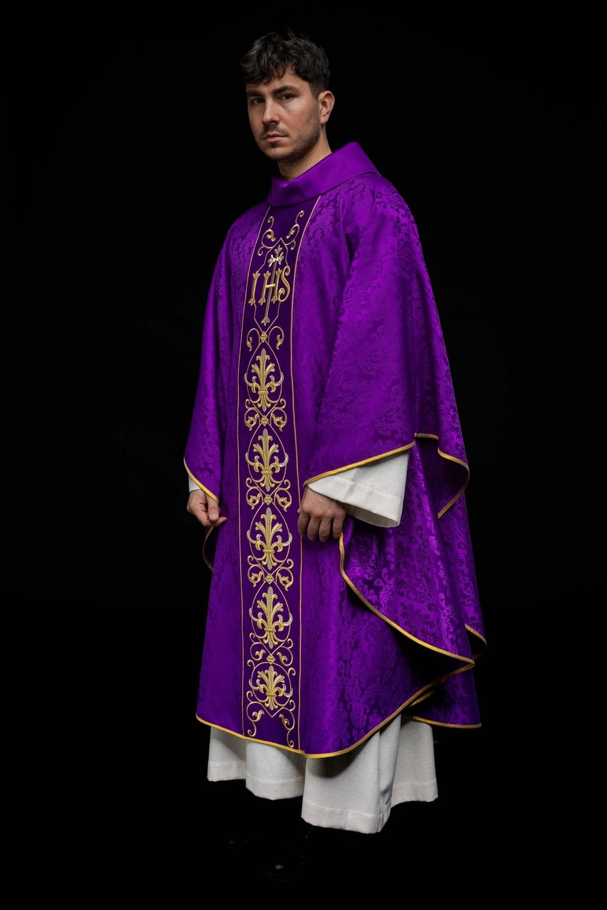 Purple chasuble, angled front view with embroidered IHS panel and gold trim