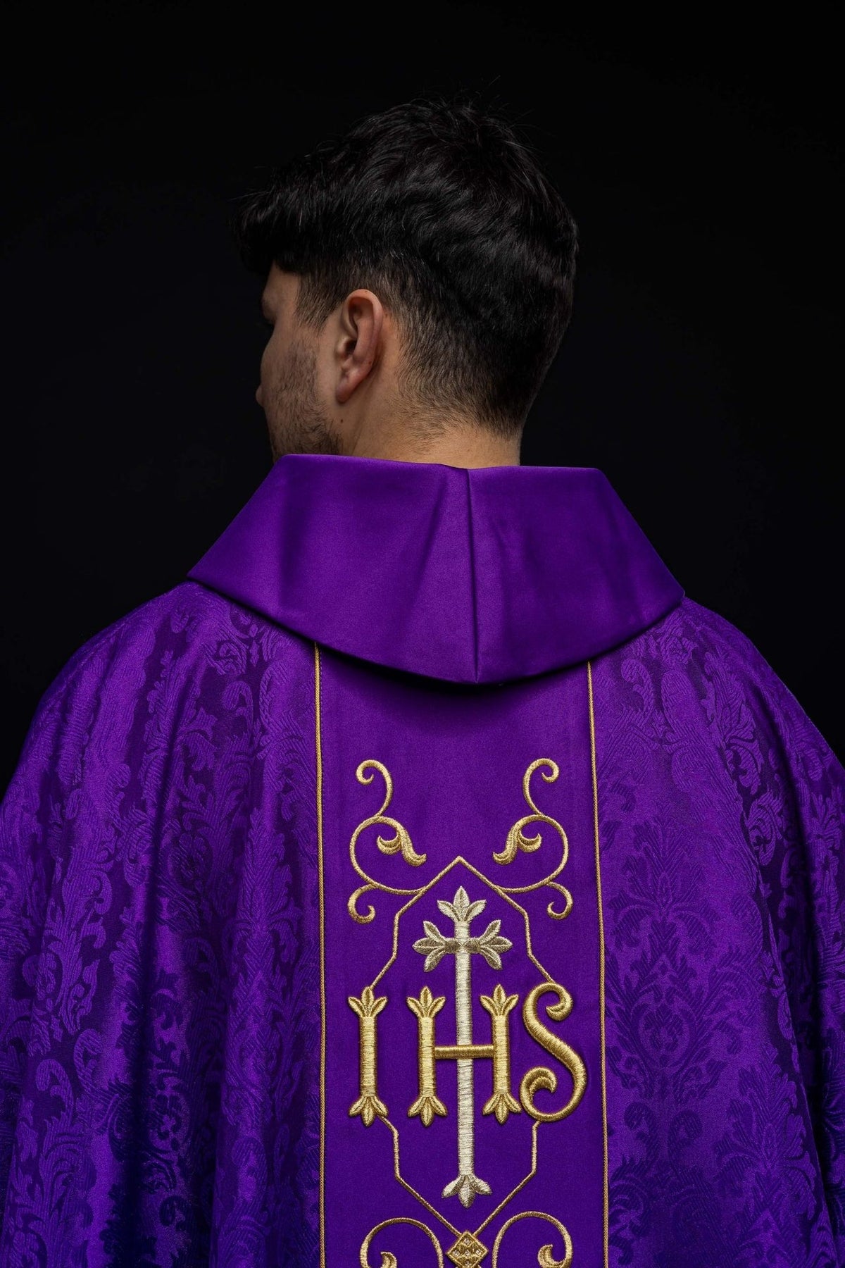 Purple chasuble worn from the back with embroidered IHS panel and stand-up collar