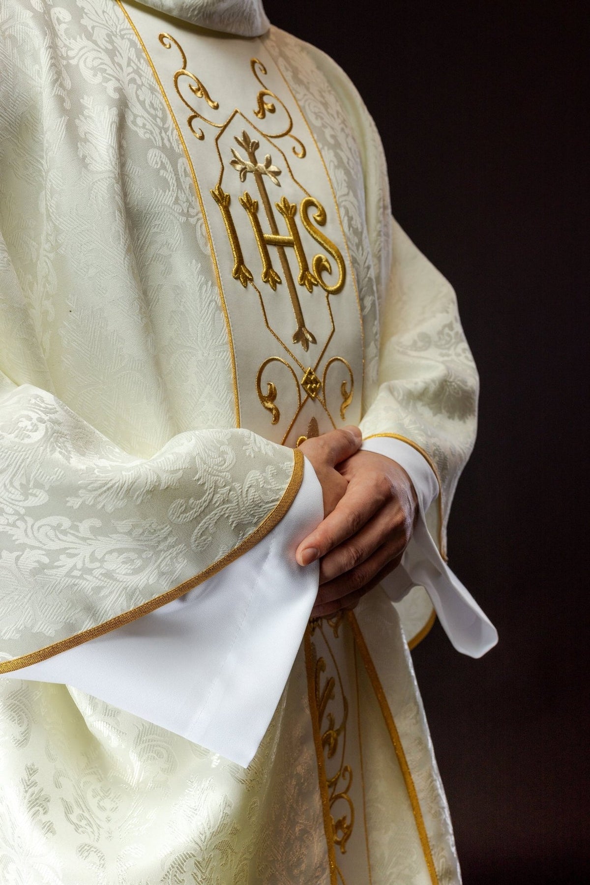 Ecru chasuble front detail showing floral damask pattern and gold trim