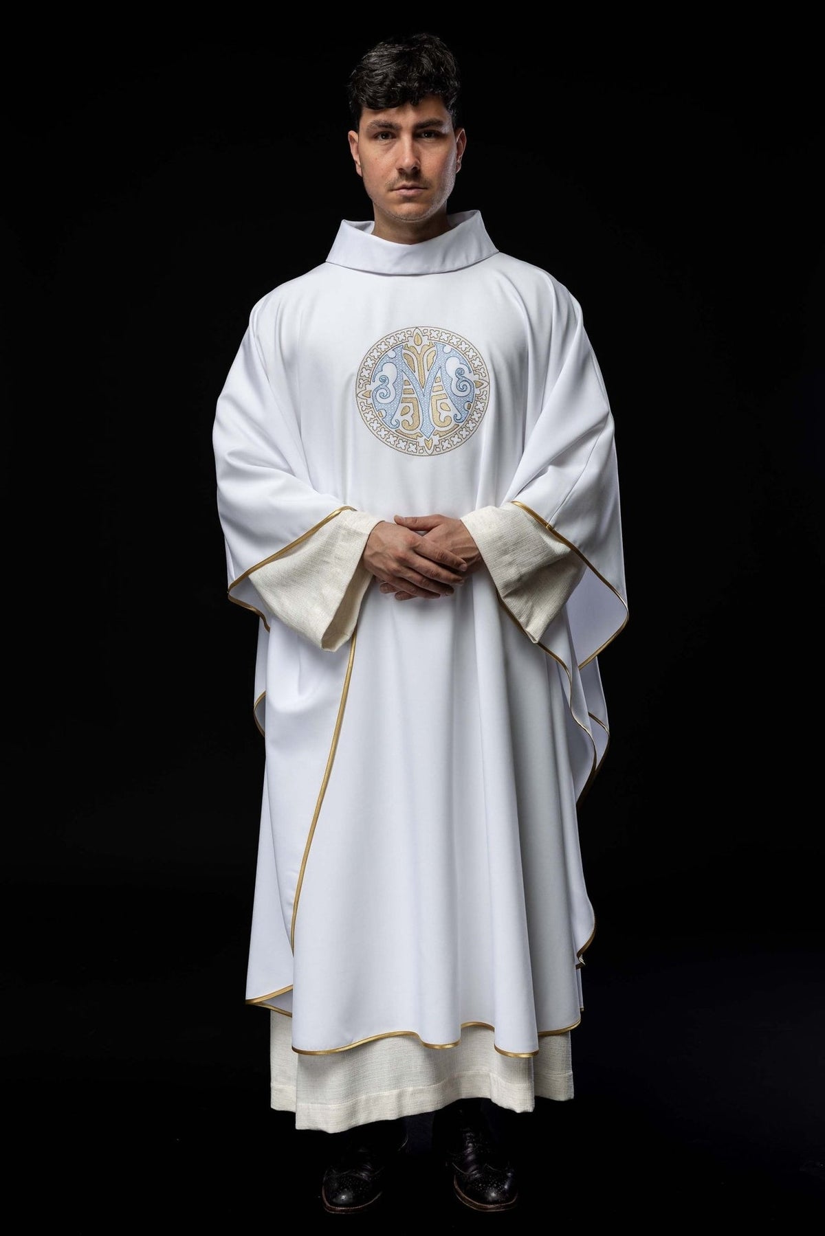 Marian chasuble worn from the front, showing wide sleeves, gold trim and central Marian motif