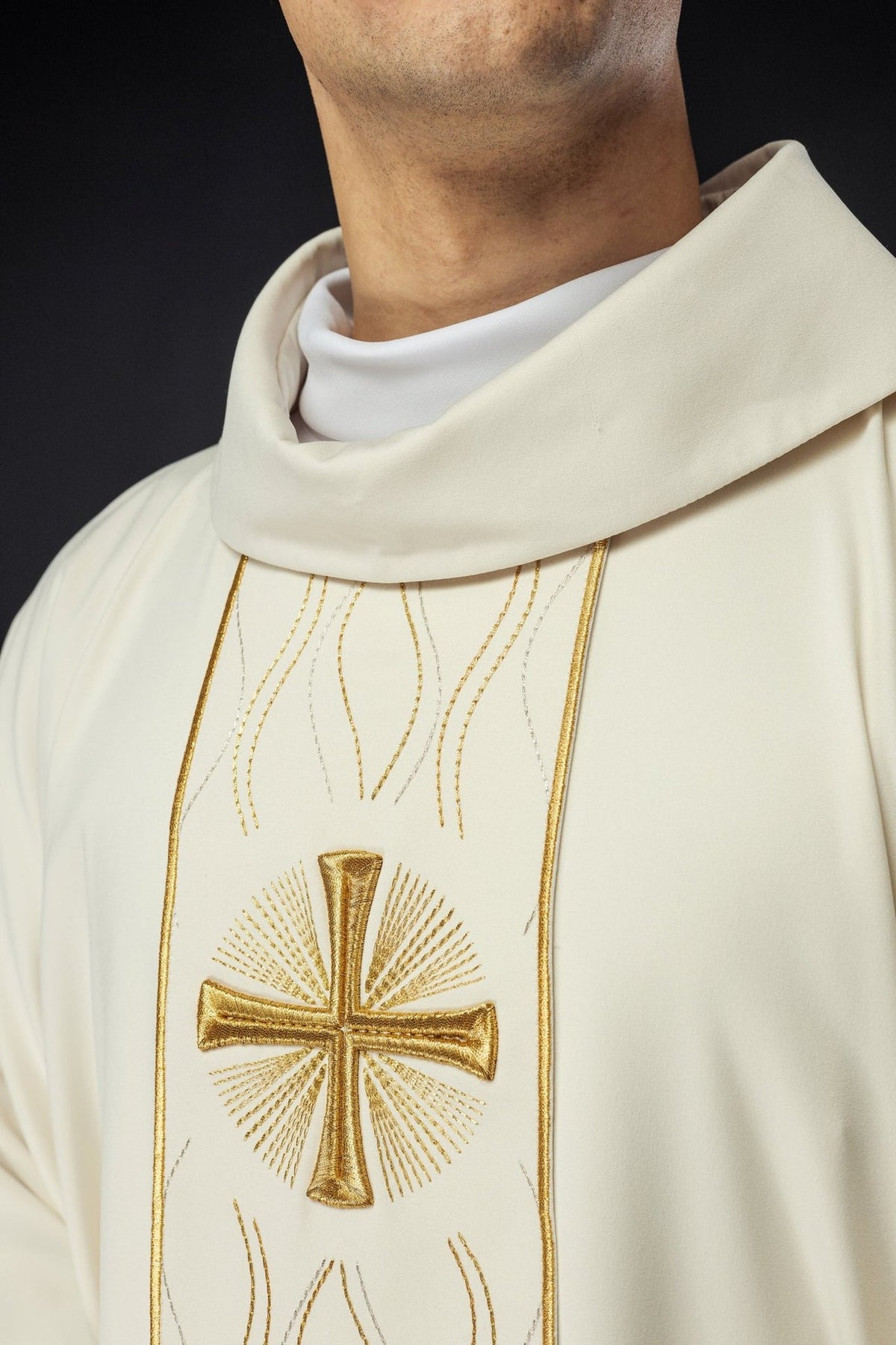 Ecru chasuble close-up showing stand-up collar and gold cross embroidery