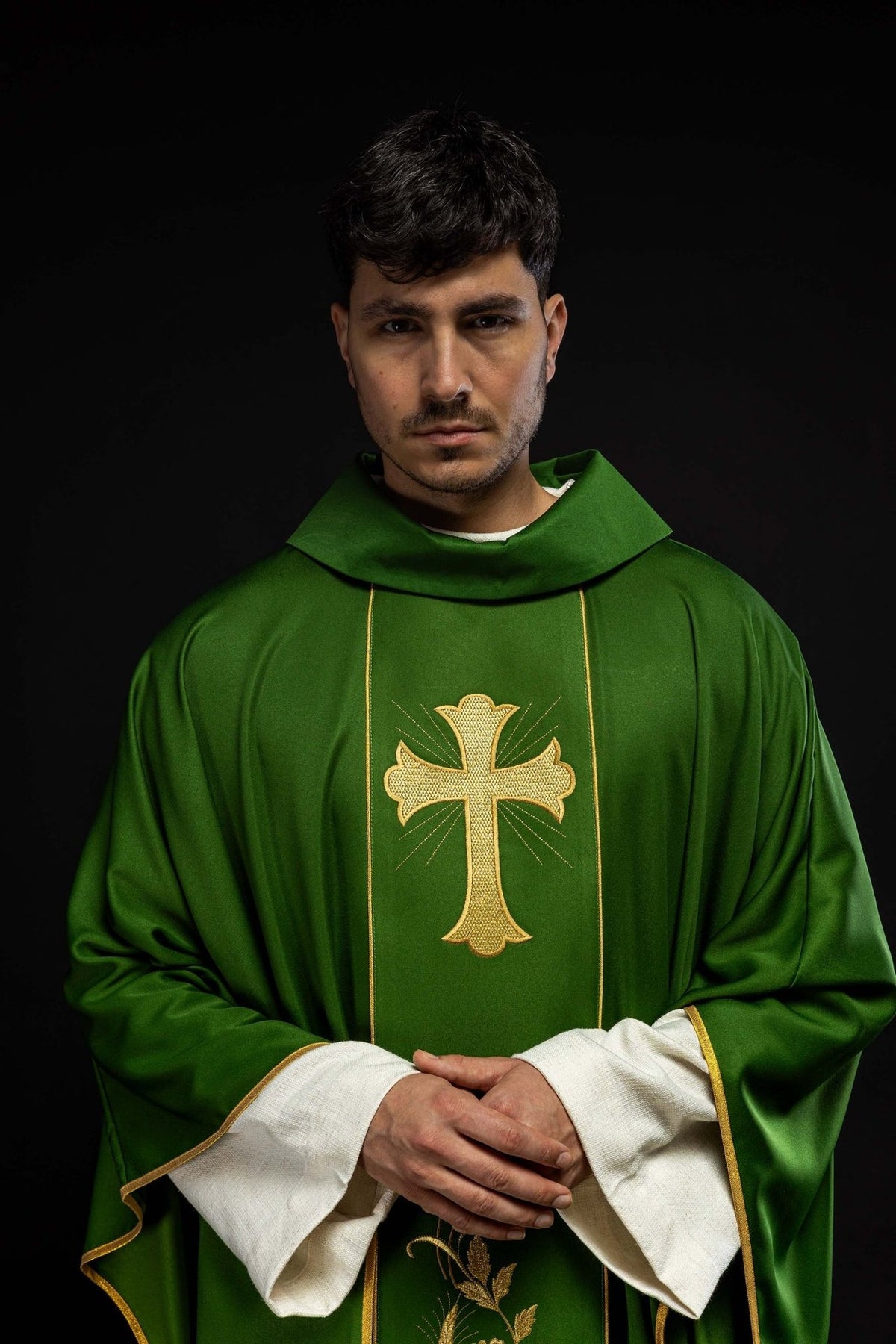 Green chasuble front close-up with gold embroidered cross