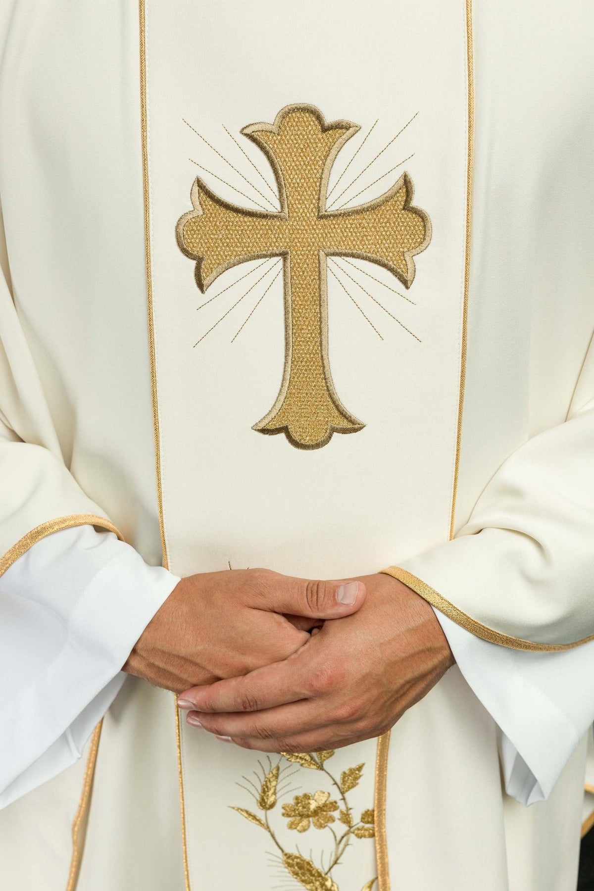 Ecru chasuble close-up of gold-embroidered cross and trim