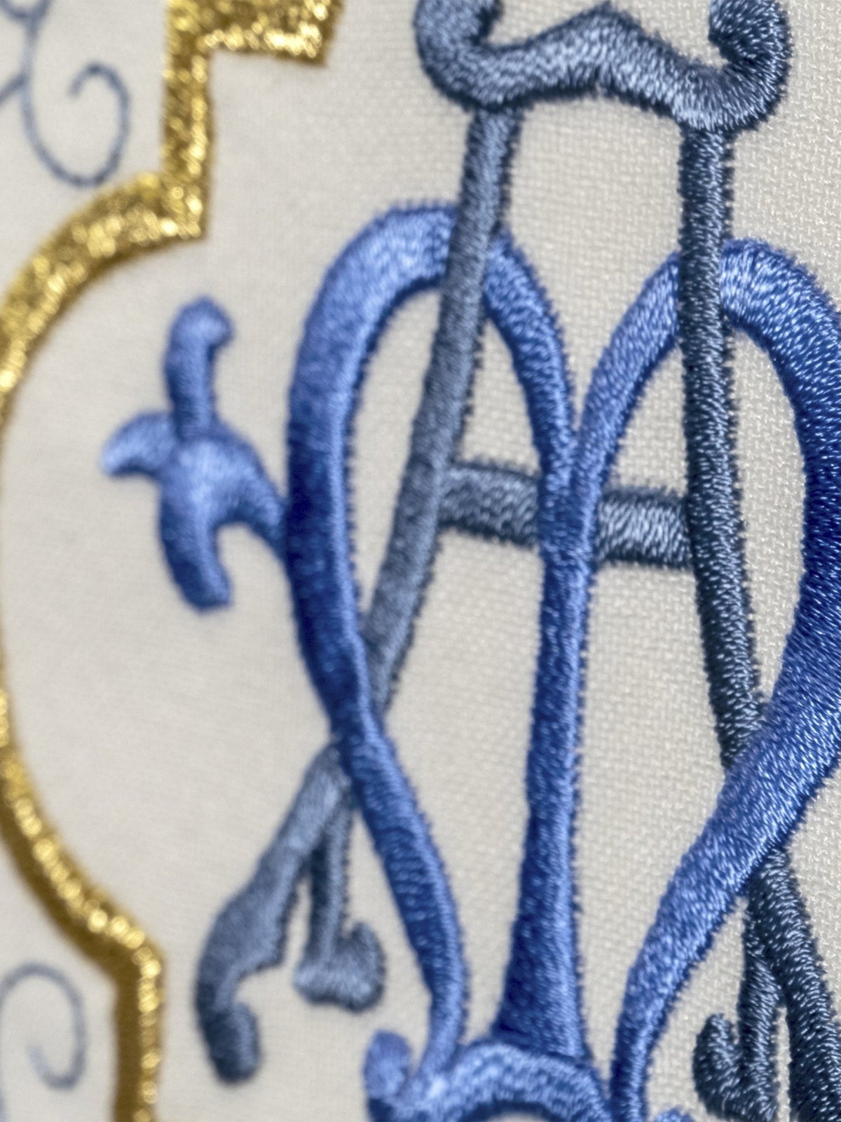 Marian chasuble, close-up of blue embroidered Marian monogram and gold trim