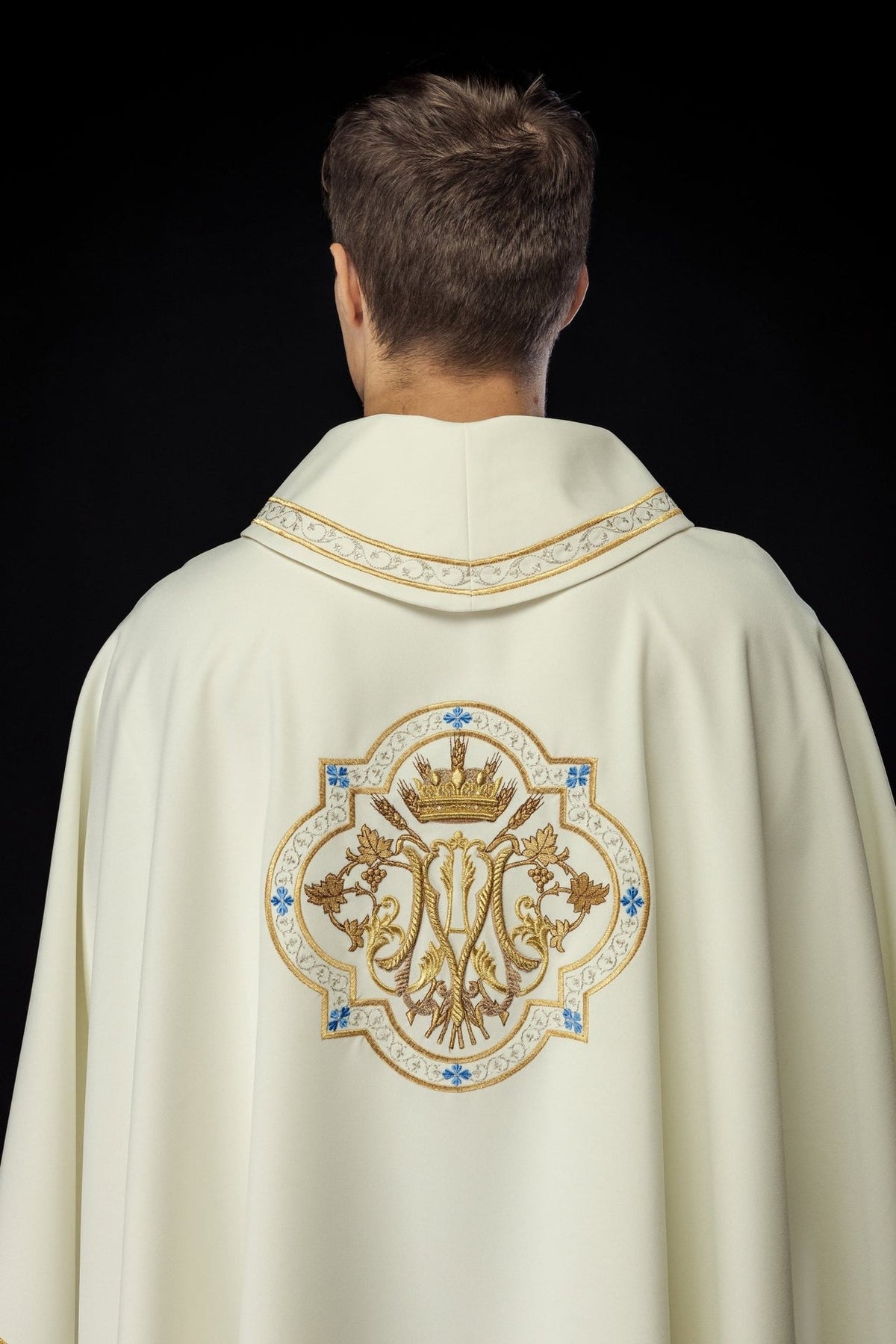 Ecru chasuble back view with embroidered Marian motif and gold-trimmed collar