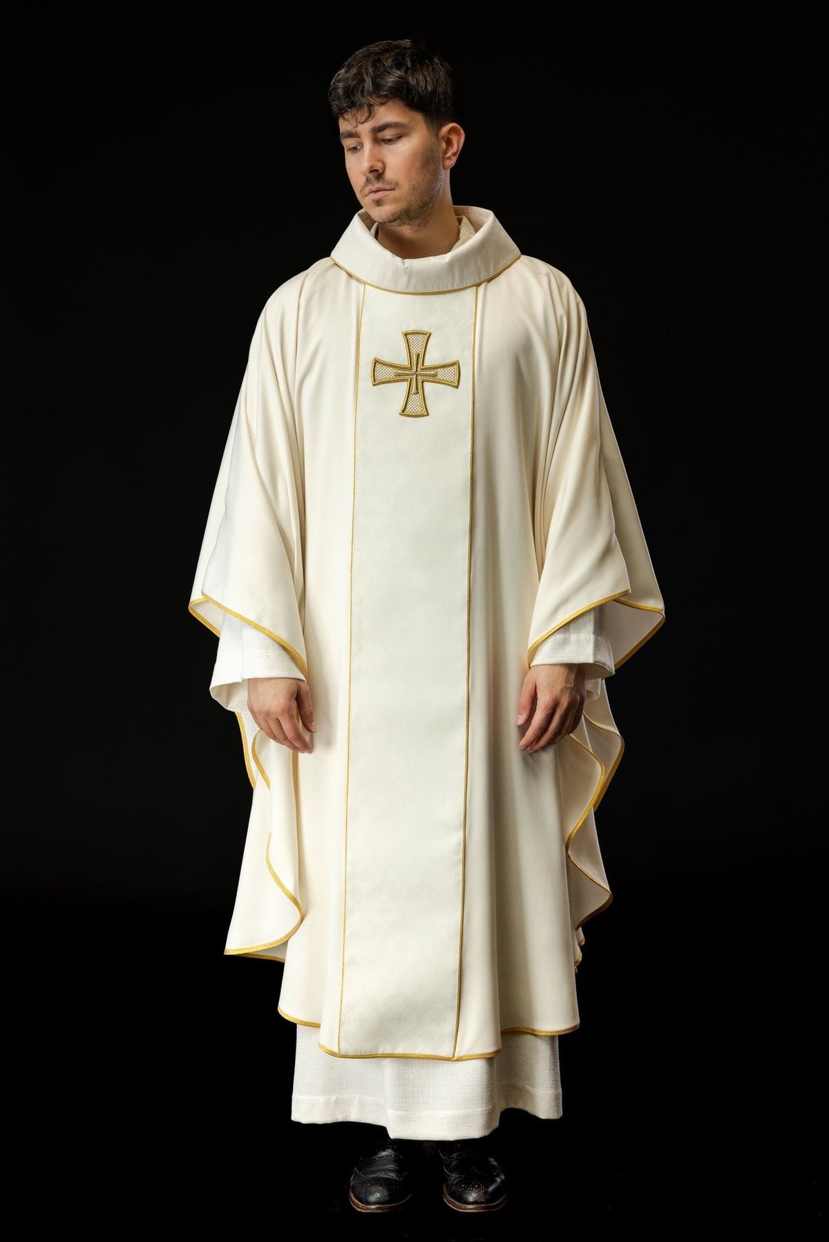 Catholic chasuble front view showing ivory fabric, gold trim and embroidered cross