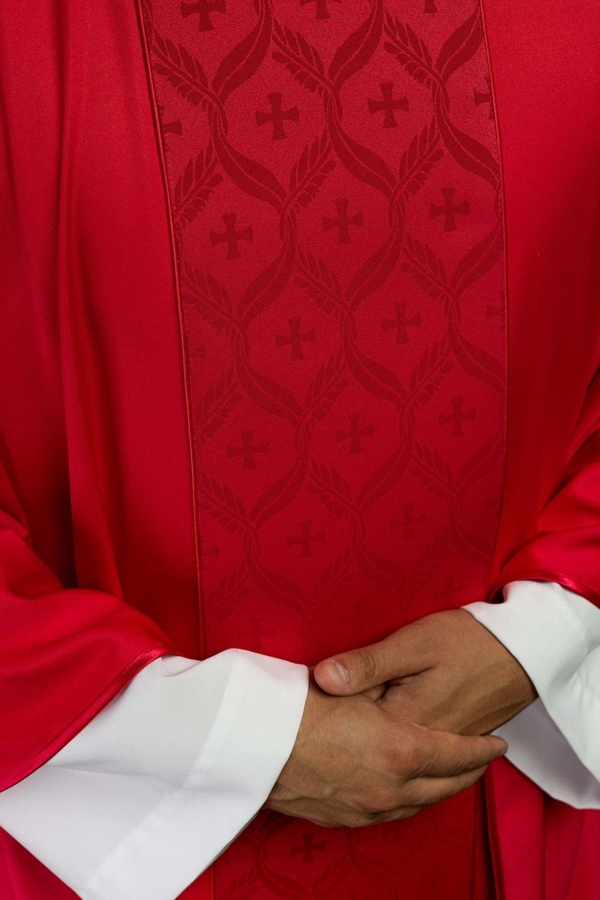 Red chasuble jacquard orphrey close-up with repeating crosses