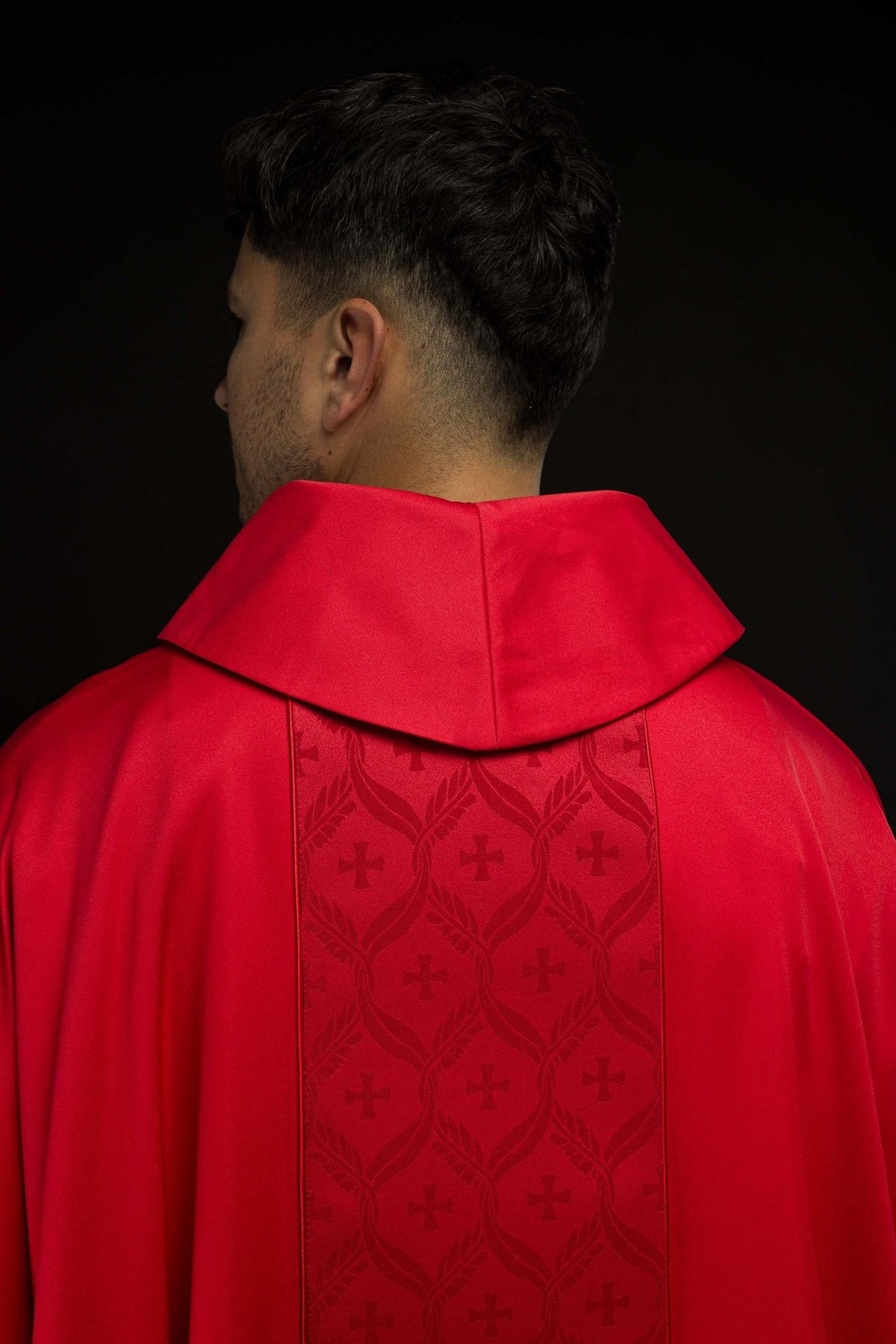 Red chasuble back view with jacquard orphrey and crosses
