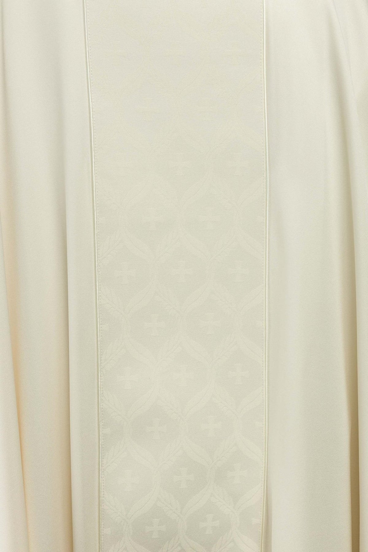 Ecru chasuble close-up showing jacquard orphrey with crosses