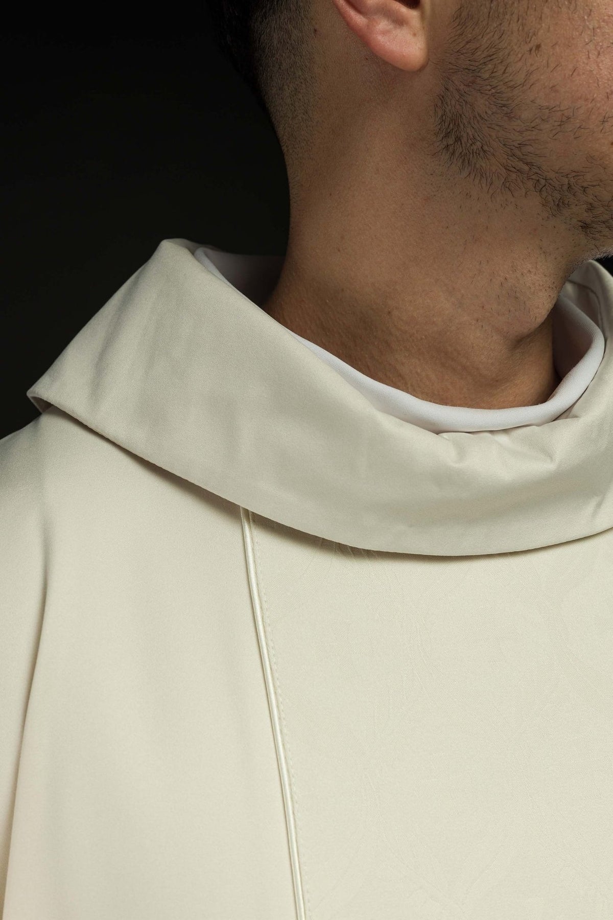 Ecru chasuble close-up showing stand-up collar and front trim