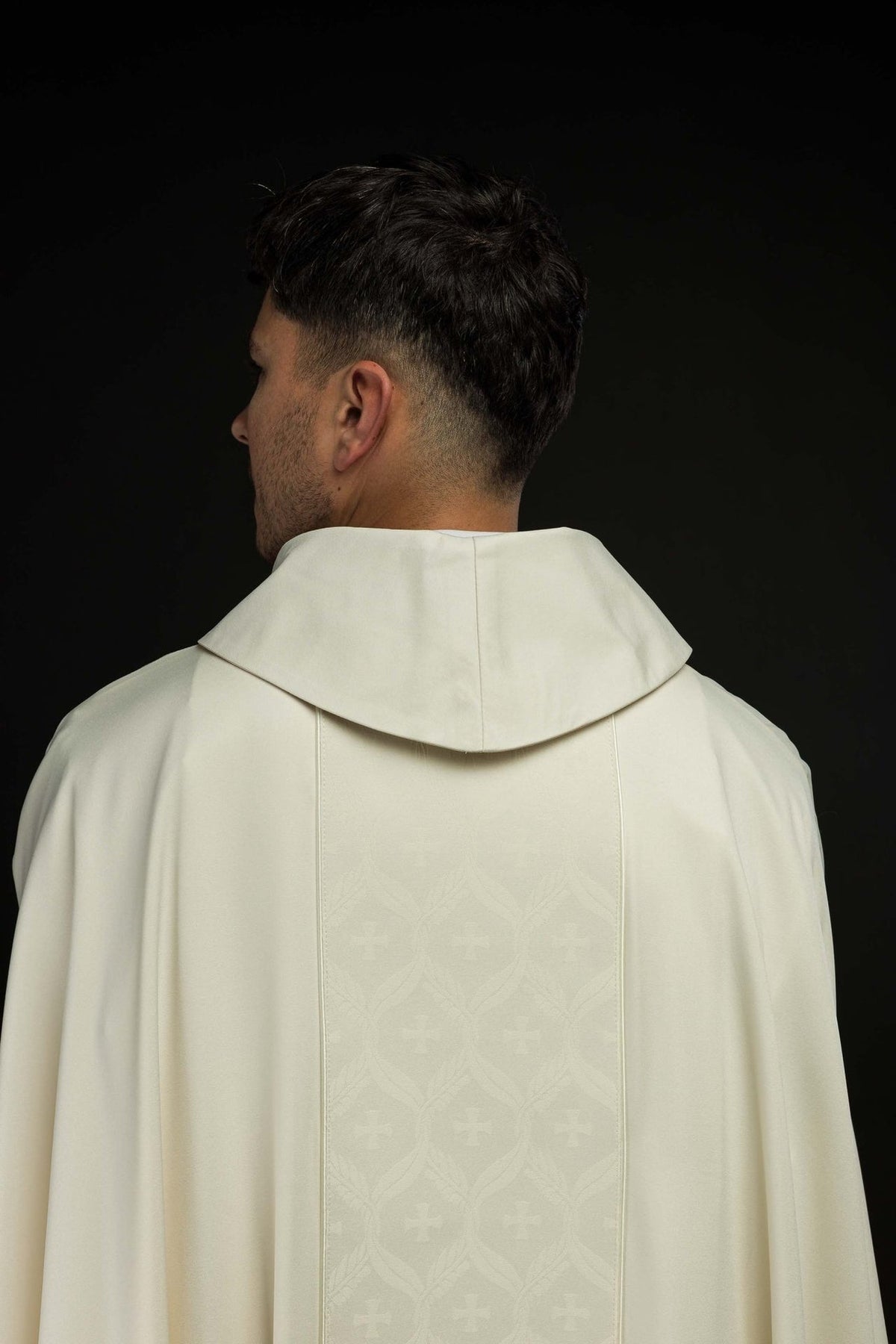 Ecru chasuble back view with jacquard orphrey and cross motifs