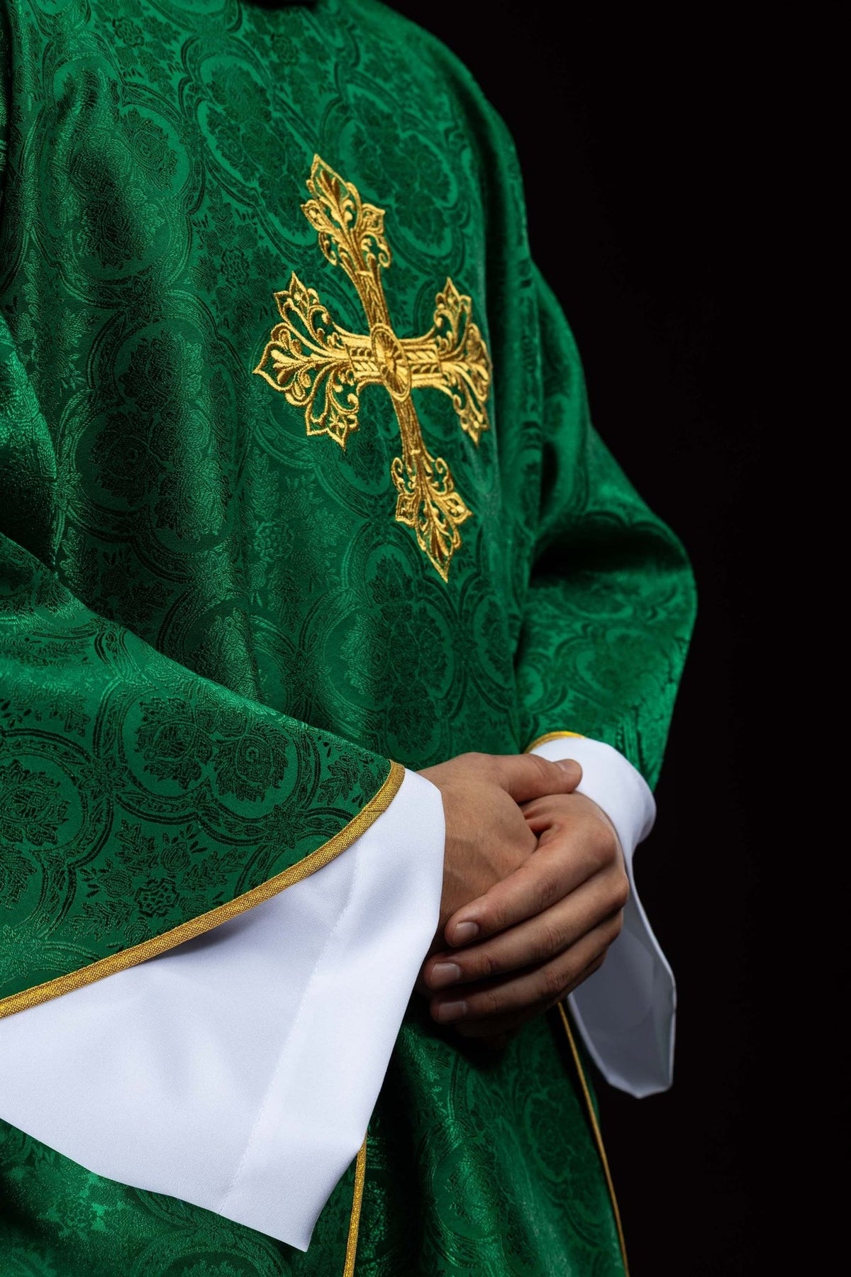 Green chasuble side view showing embroidered gold cross and gold trim