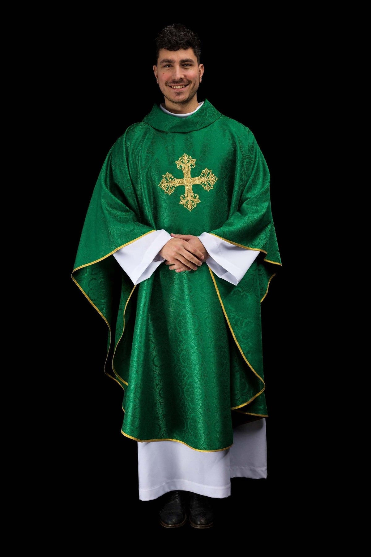 Green chasuble worn from the front, showing gold cross and trim