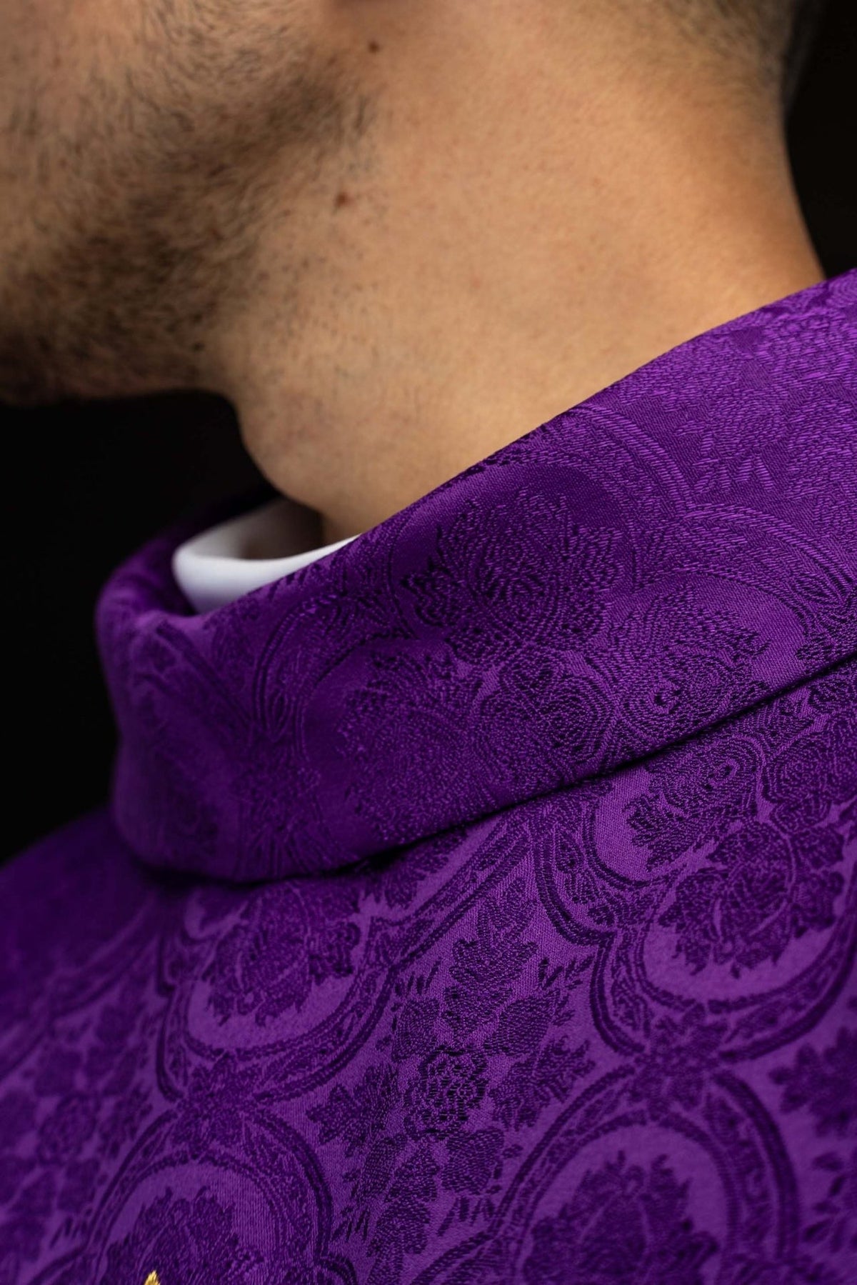 Purple chasuble close-up showing purple patterned stand-up collar