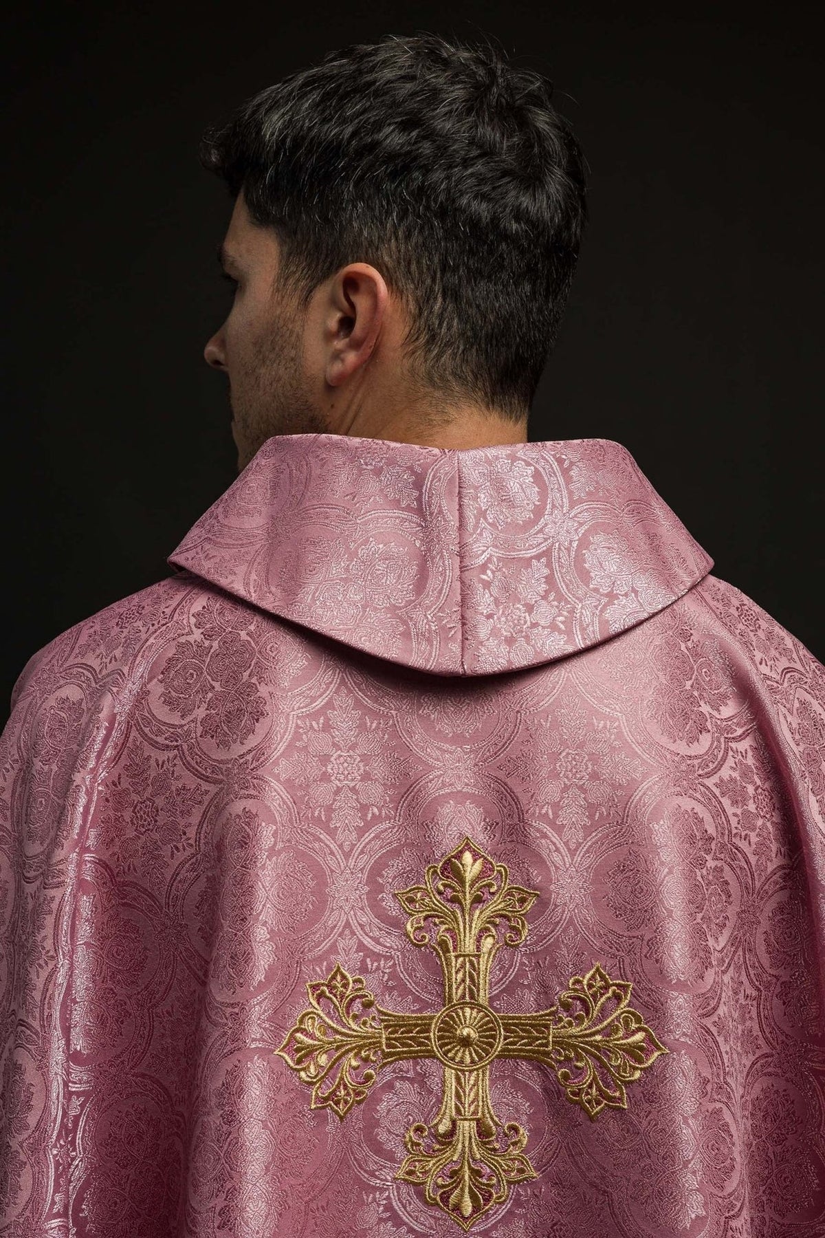 Rose chasuble back view with gold embroidered cross and patterned fabric