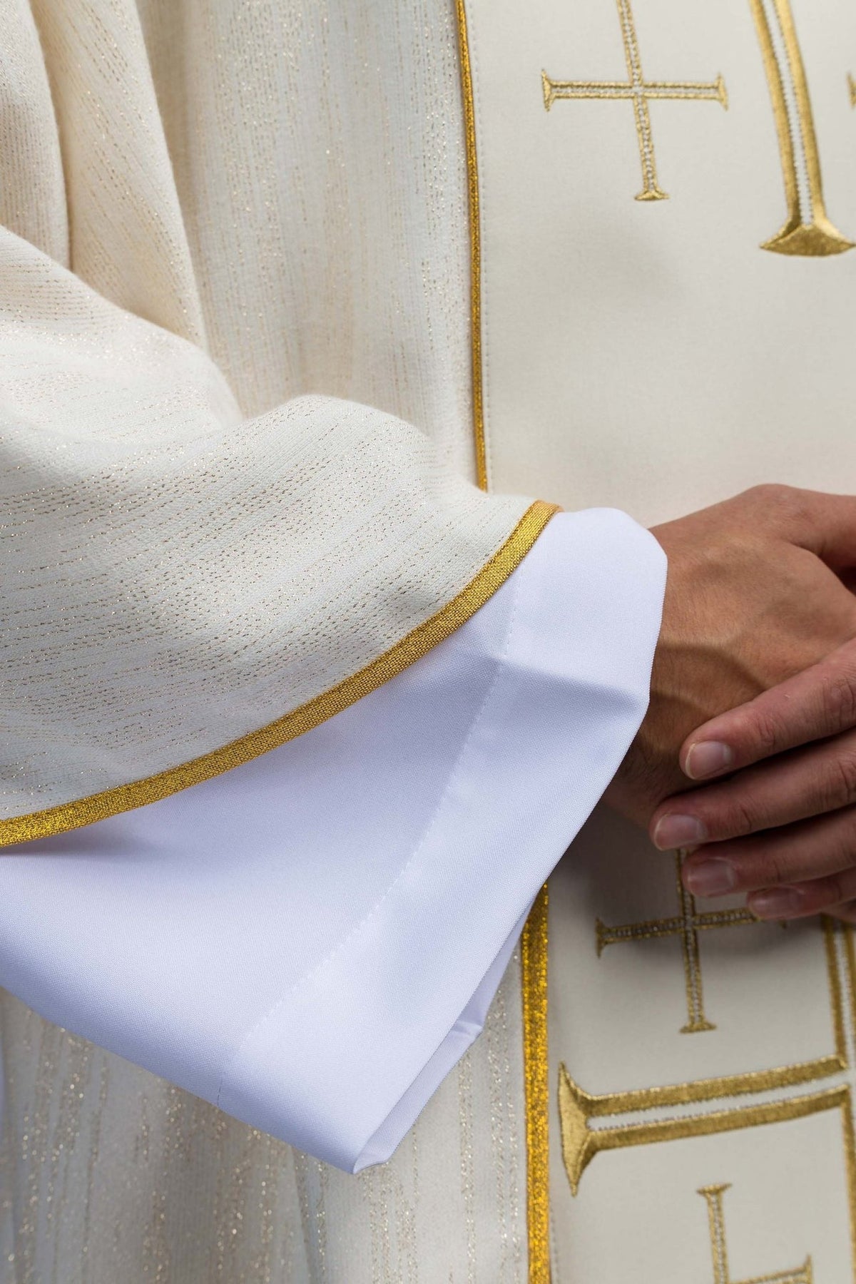 Ecru chasuble sleeve close-up with gold trim