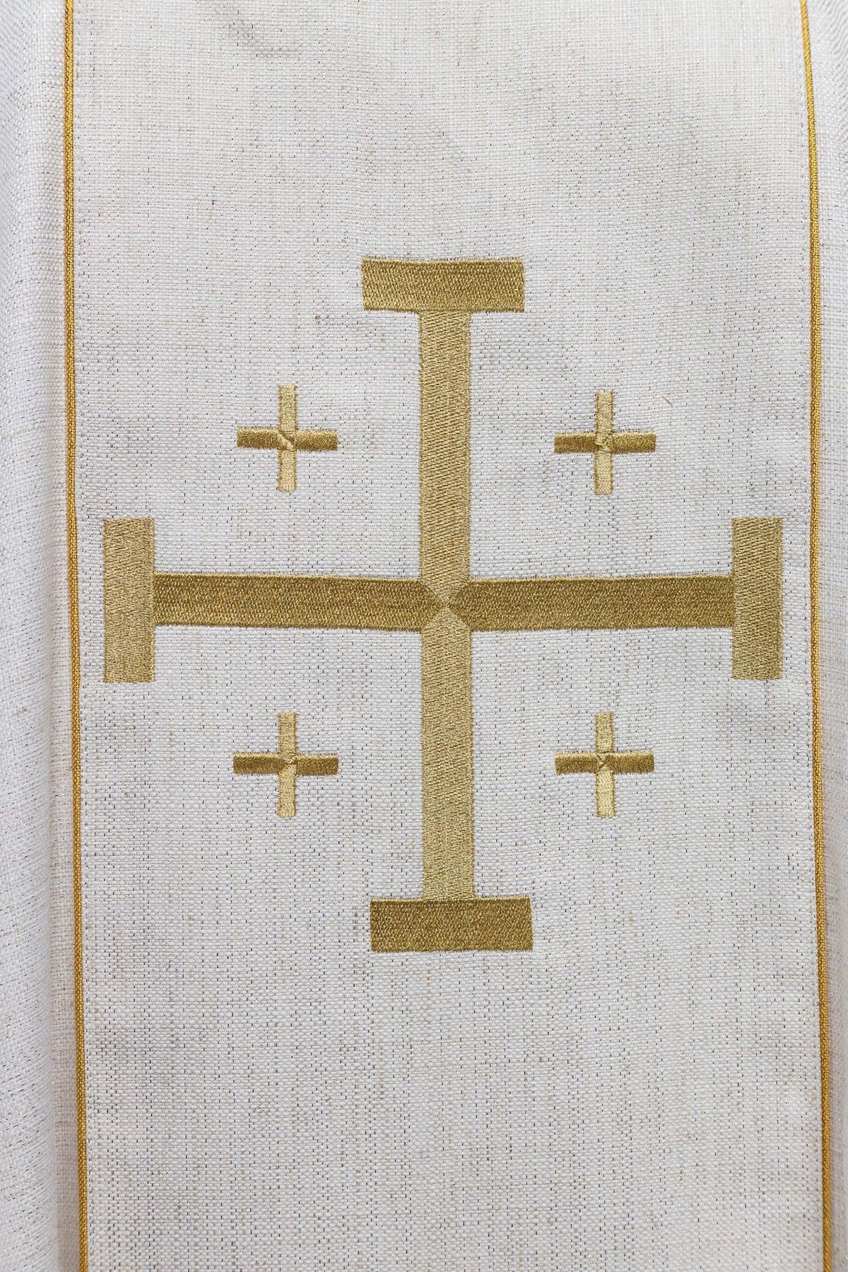 Close-up of gold Jerusalem cross embroidery on the ecru chasuble