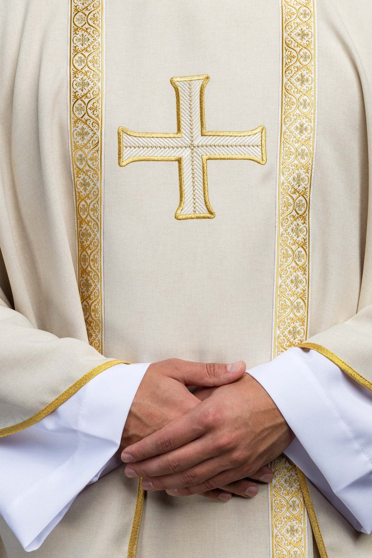 Ecru chasuble front detail showing embroidered gold cross and patterned orphrey trim