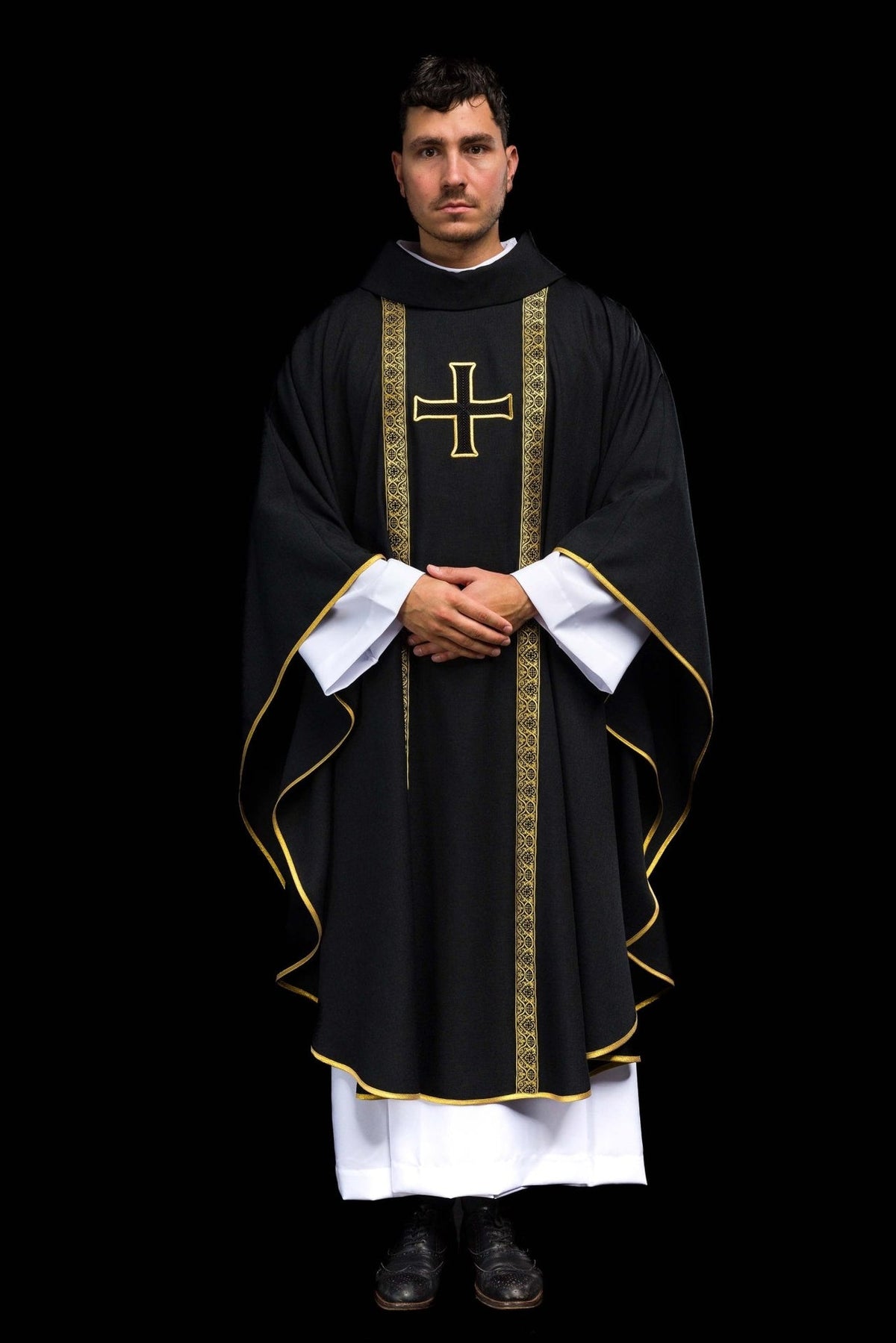 Black chasuble front view with gold embroidered cross and jacquard orphreys