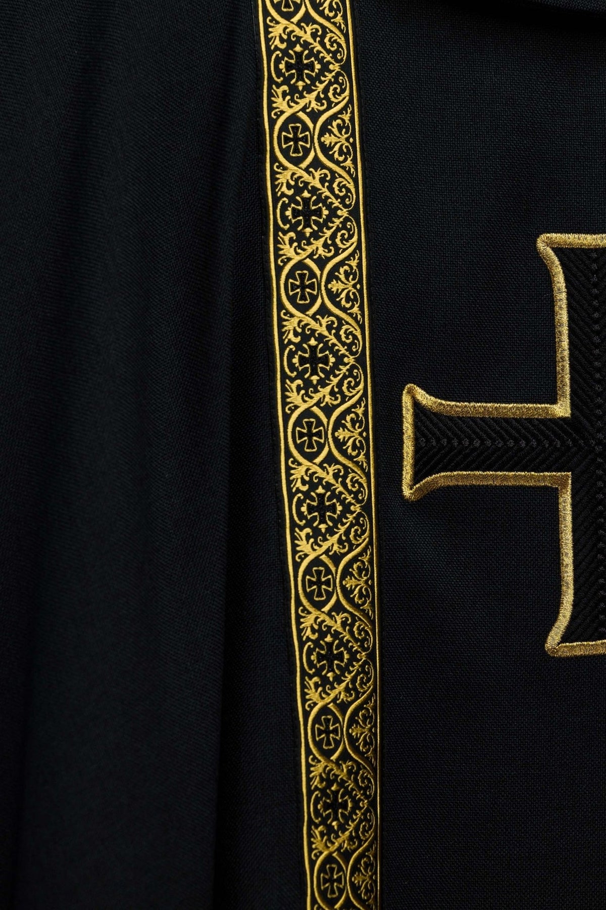 Black chasuble close-up of gold jacquard orphrey and cross embroidery