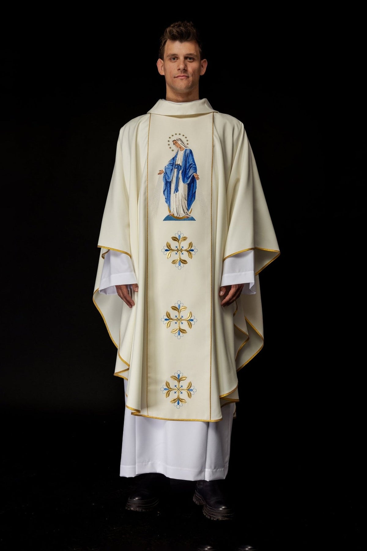 Catholic chasuble, full front view with ivory fabric, gold trim and blue-and-gold embroidered motifs
