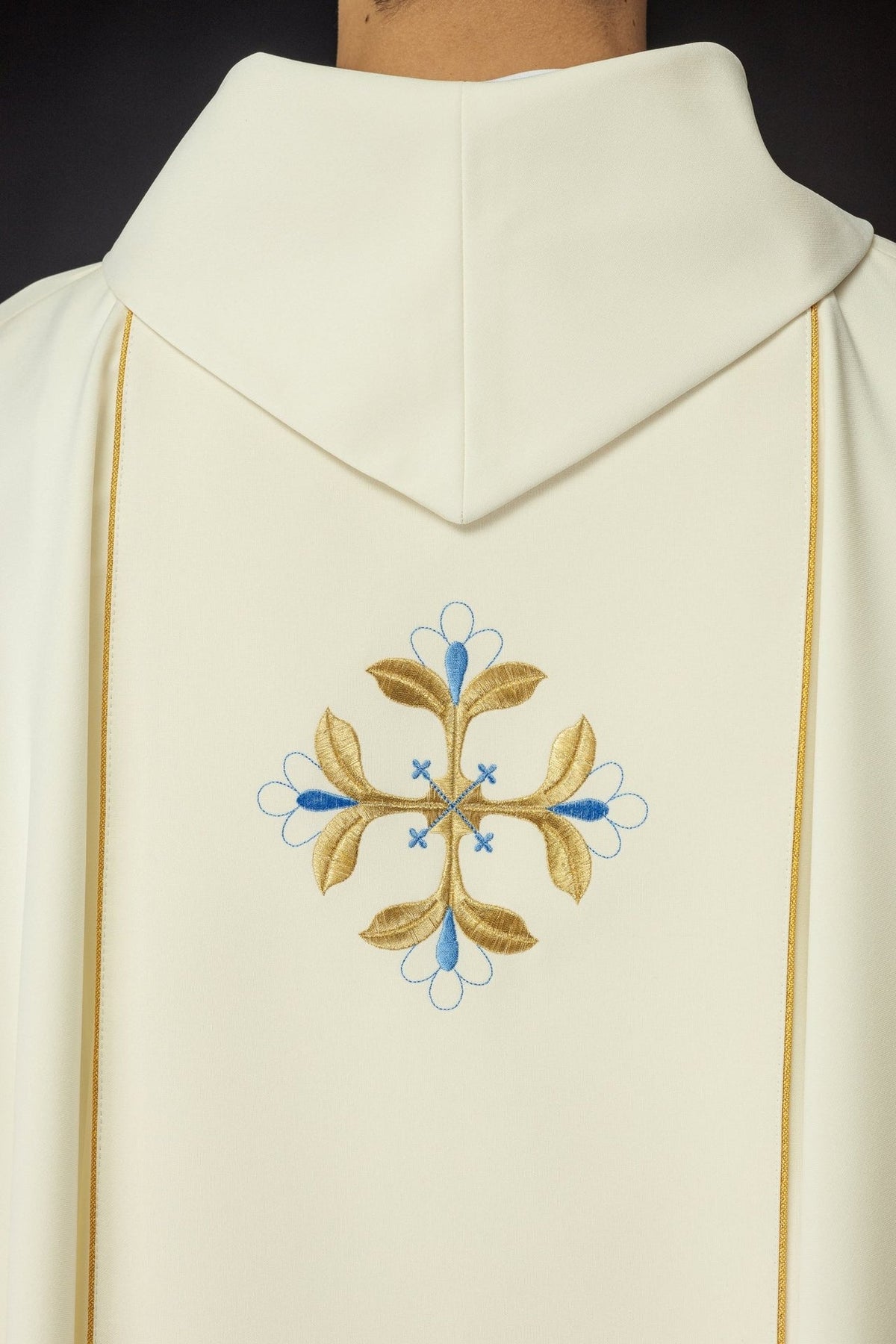 Catholic chasuble back close-up with stand-up collar, gold trim and blue-and-gold embroidered motif