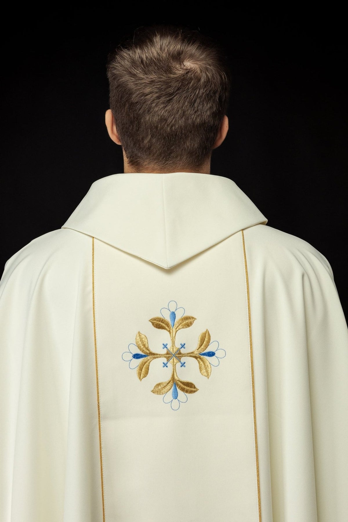 Chasuble back view with embroidered blue and gold cross motifs