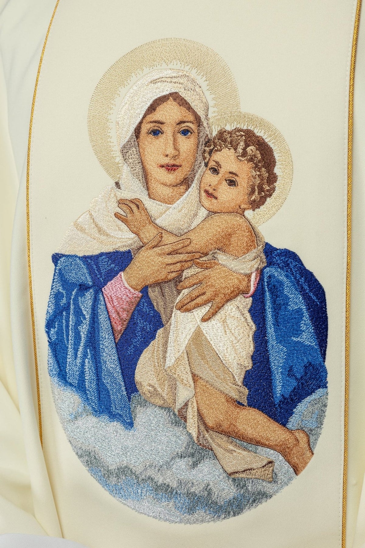 Chasuble close-up showing embroidered Our Lady and Child image in blue, ivory and gold