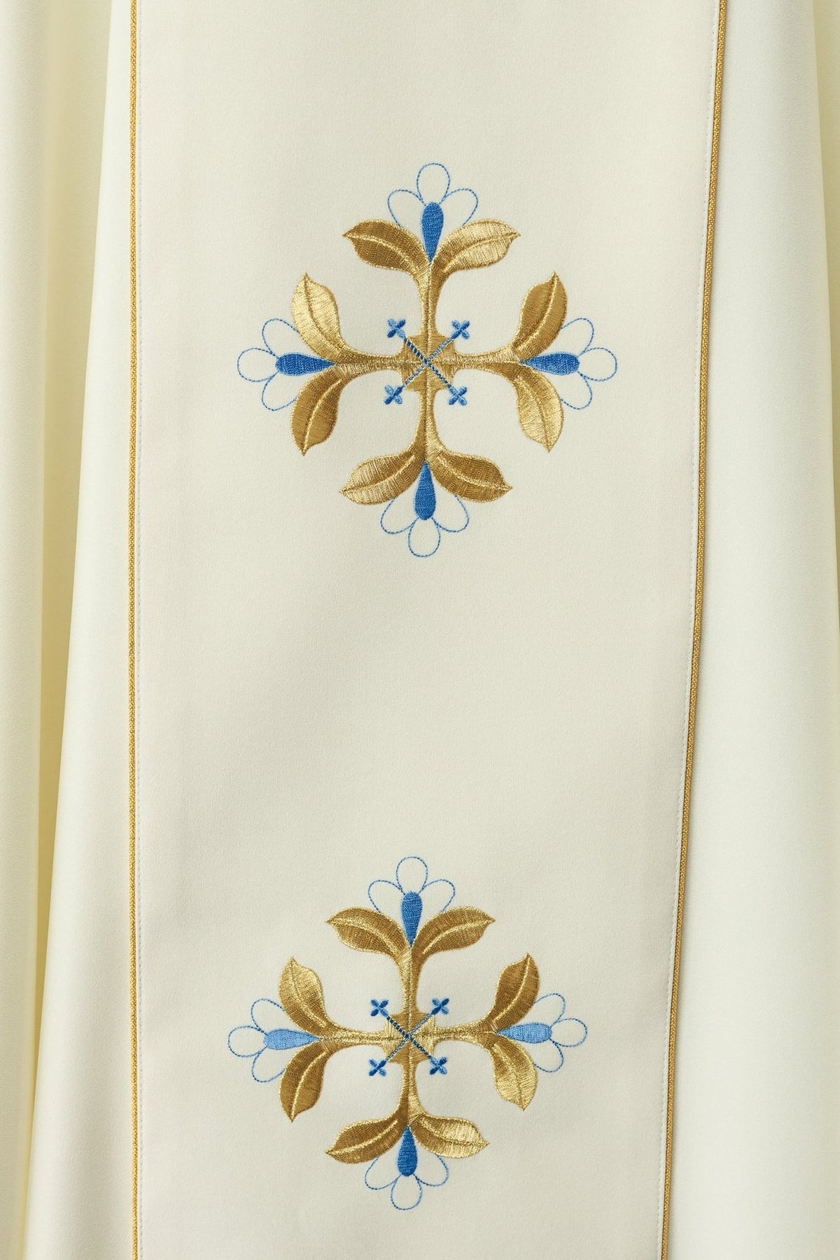 Chasuble close-up showing gold and blue floral embroidered motifs