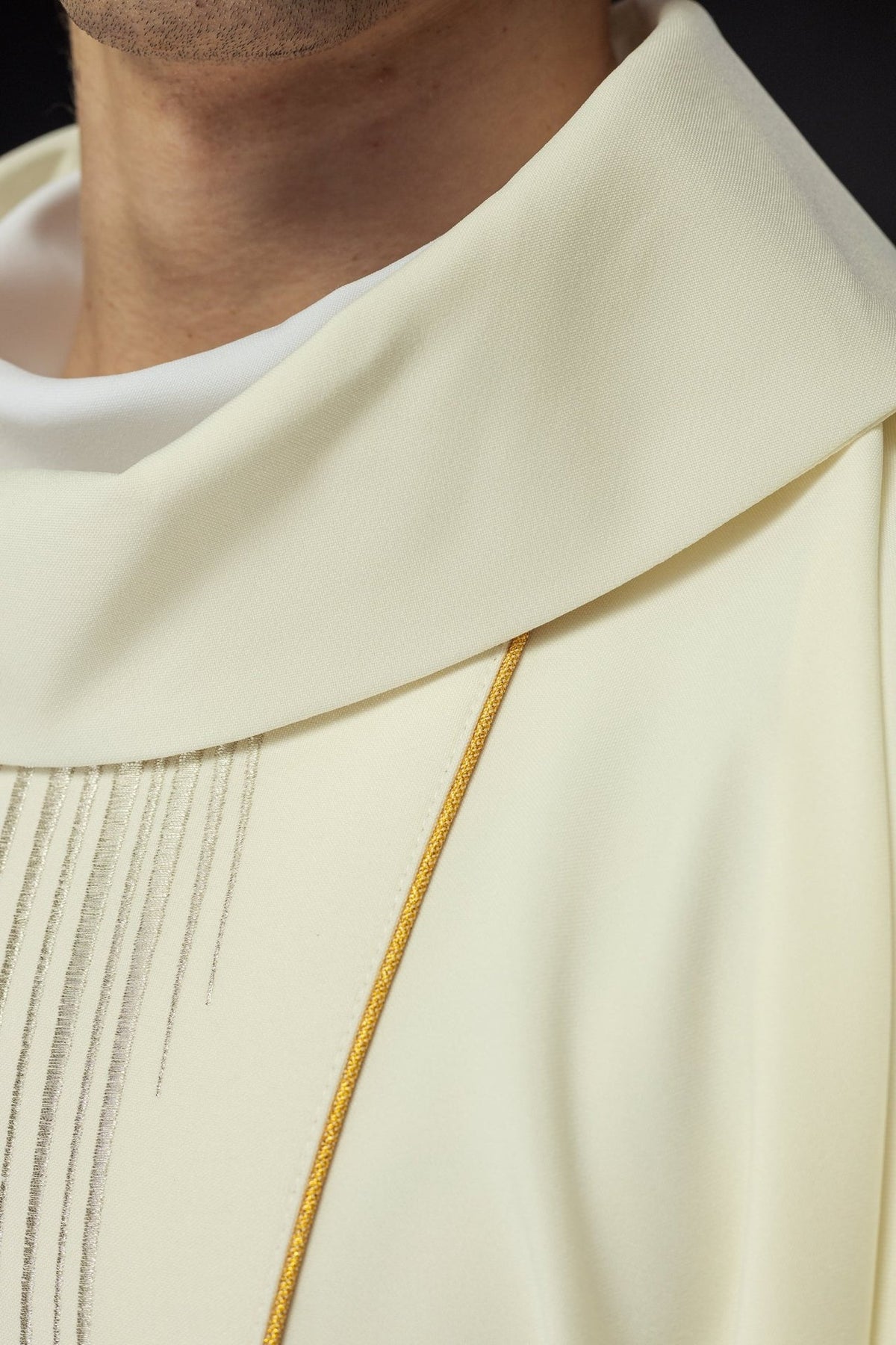 Chasuble close-up showing ivory stand-up collar and gold trim