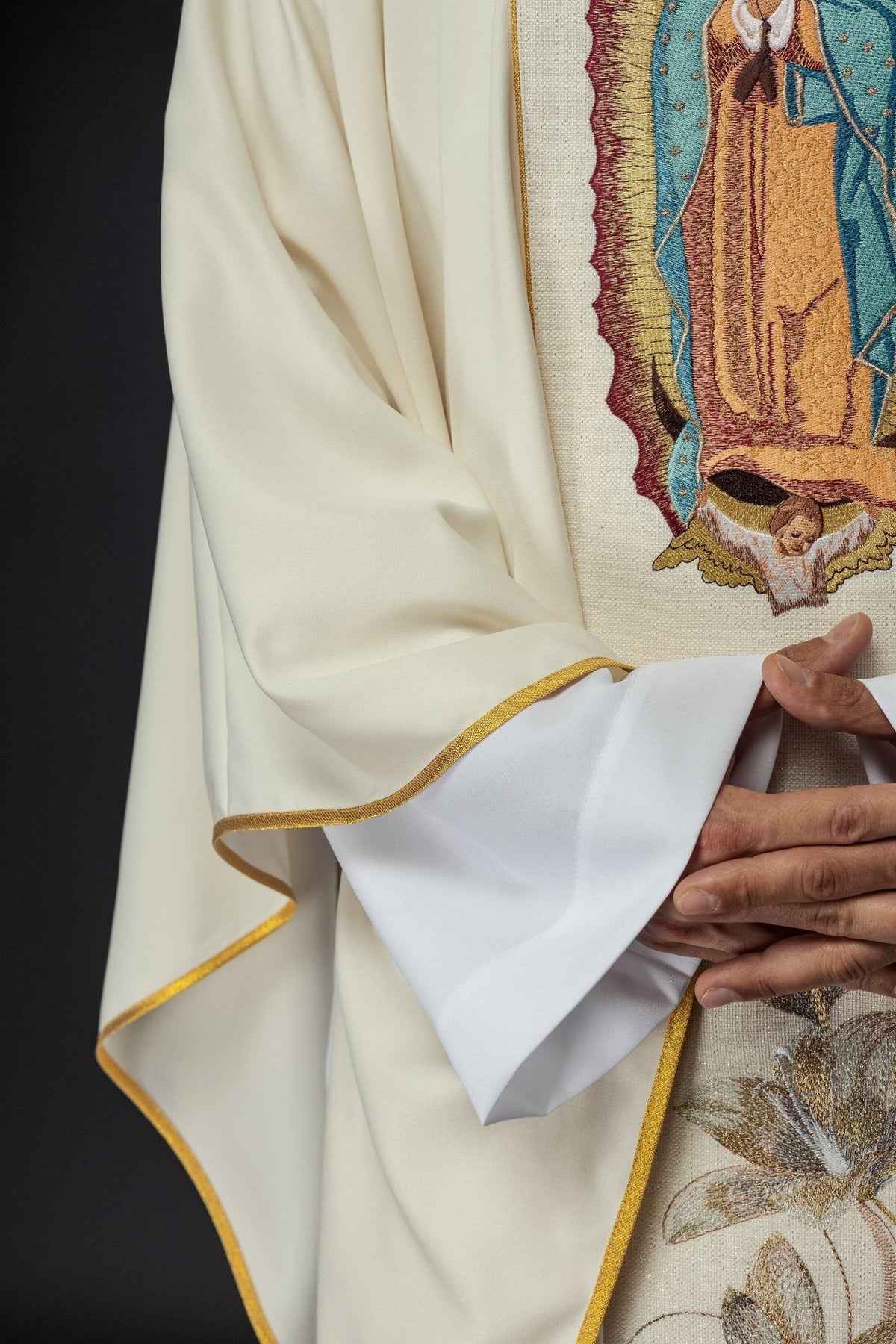 Gold chasuble sleeve close-up with satin trim