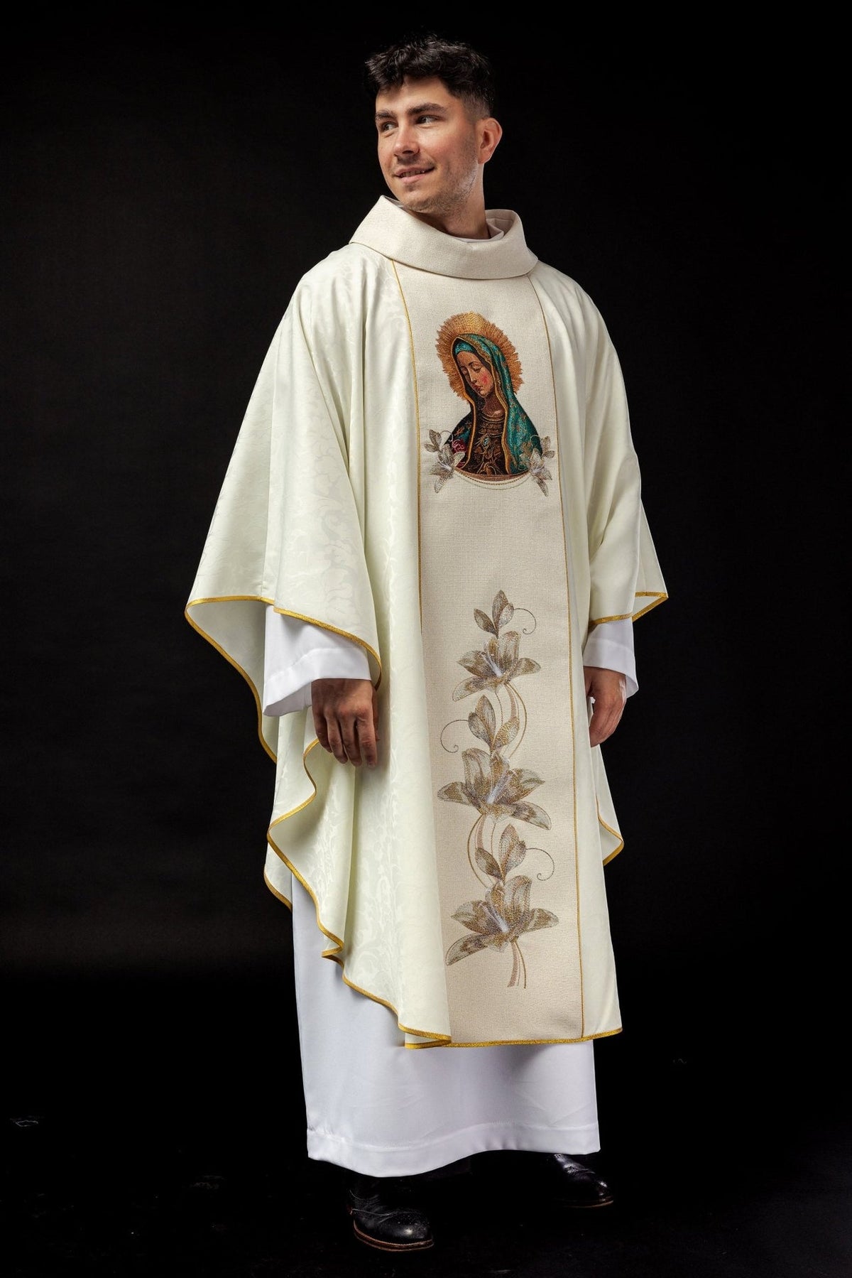 White chasuble worn, showing the Our Lady of Guadalupe embroidery and long floral orphrey