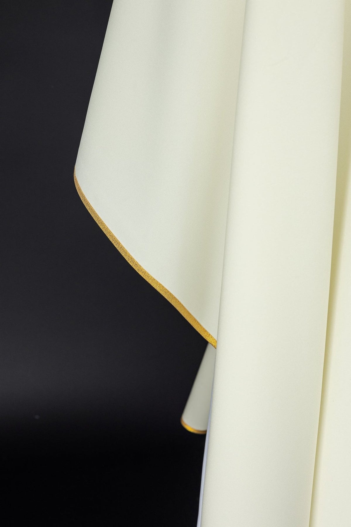 Ivory chasuble sleeve close-up with gold trim
