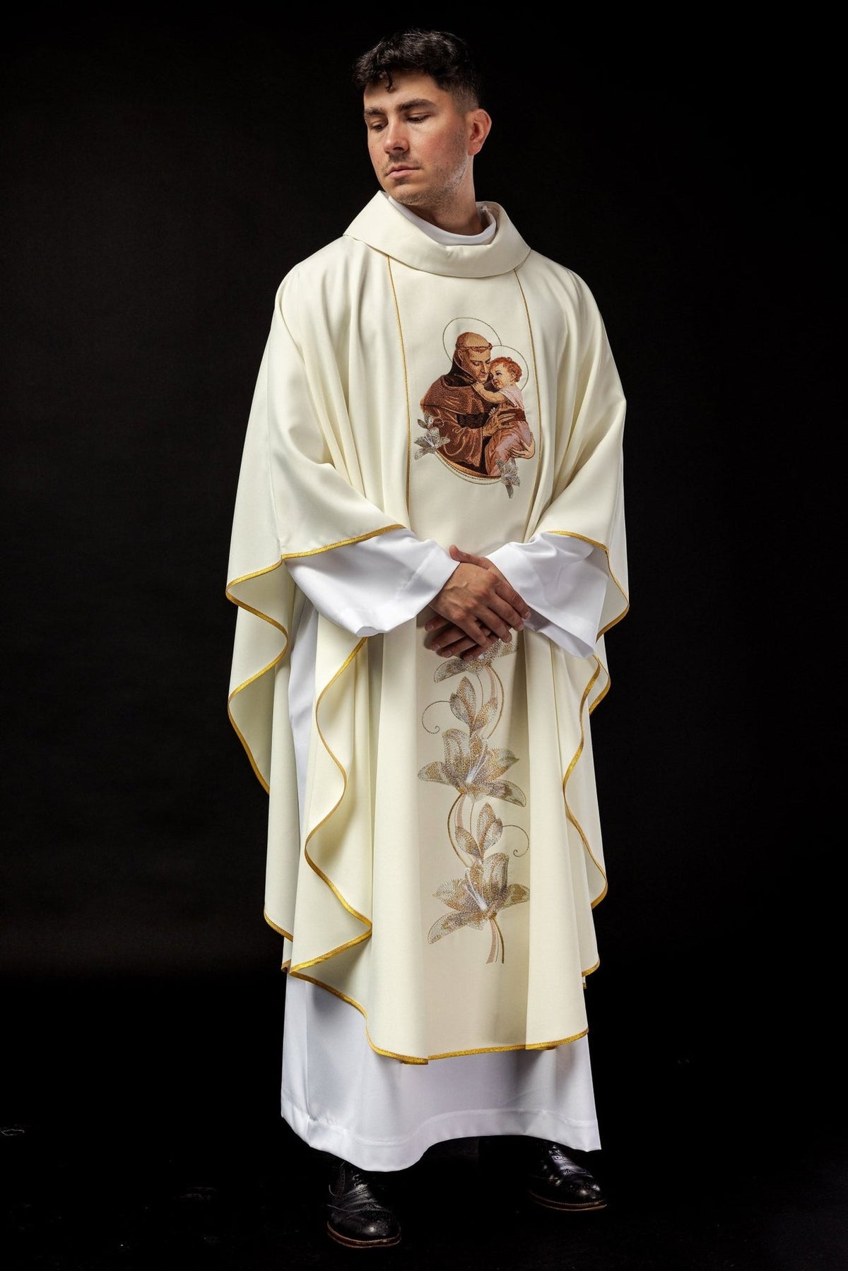 Ecru Saint Anthony chasuble worn from the front with gold trim