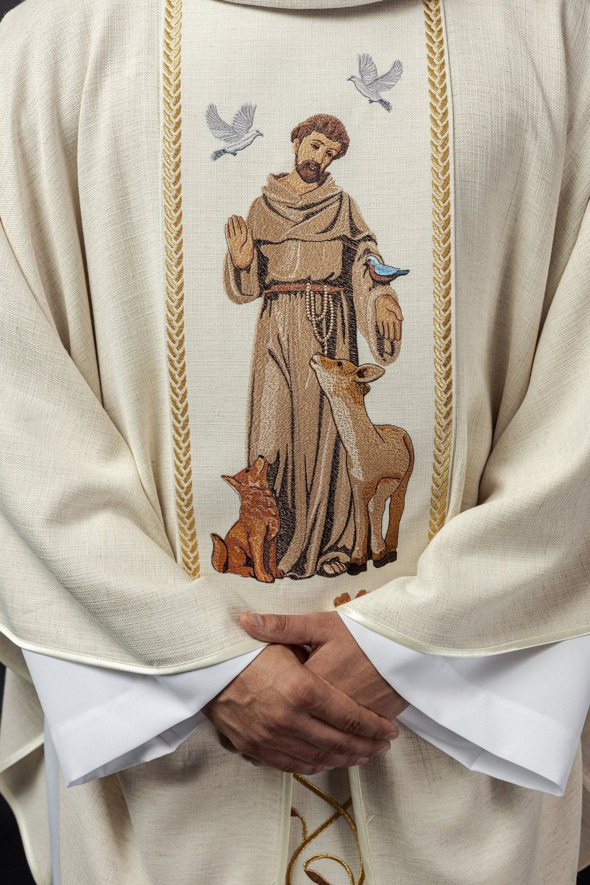 Chasuble close-up showing Saint Francis embroidery and gold trim