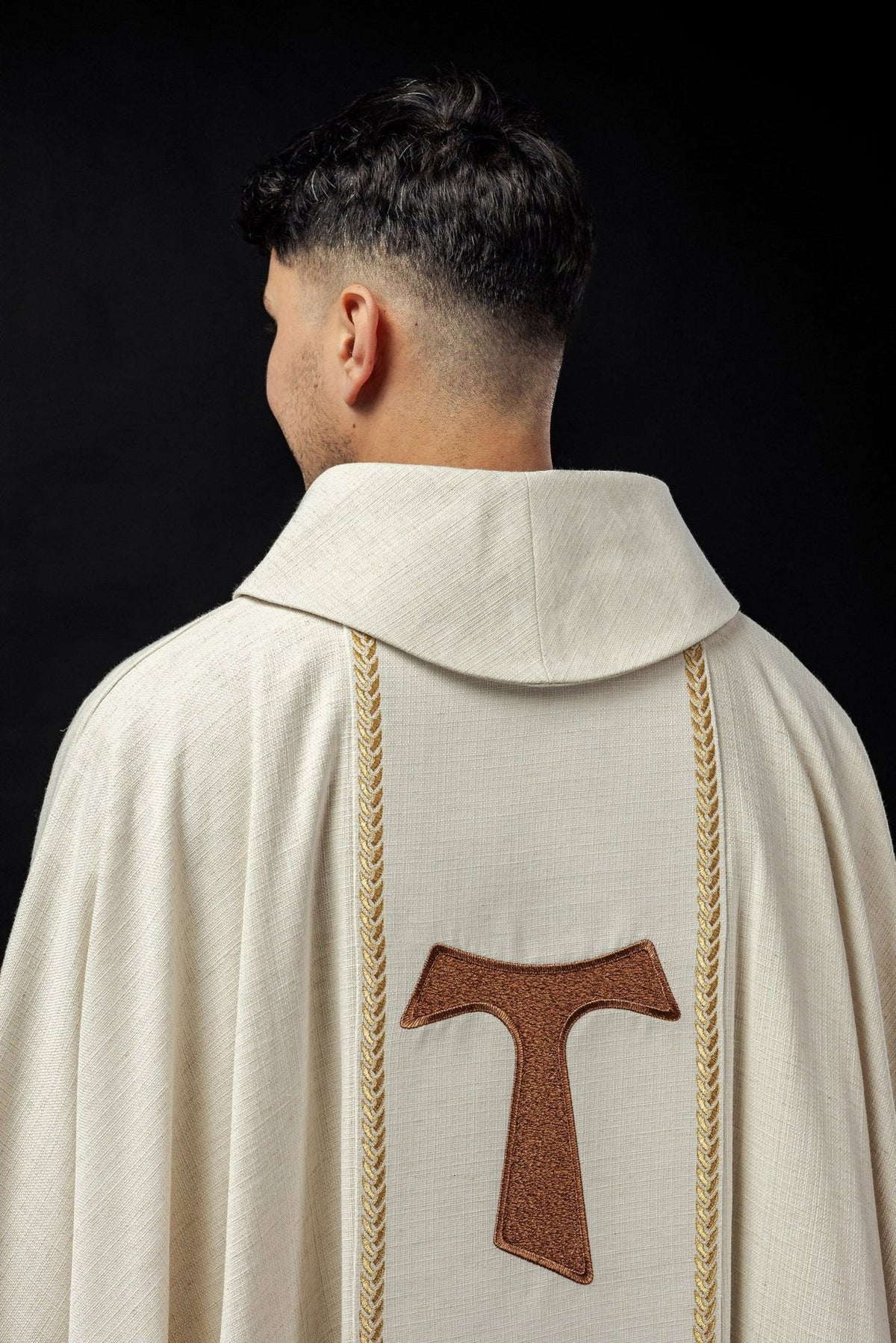 Chasuble back view with embroidered brown Franciscan cross and floral orphrey