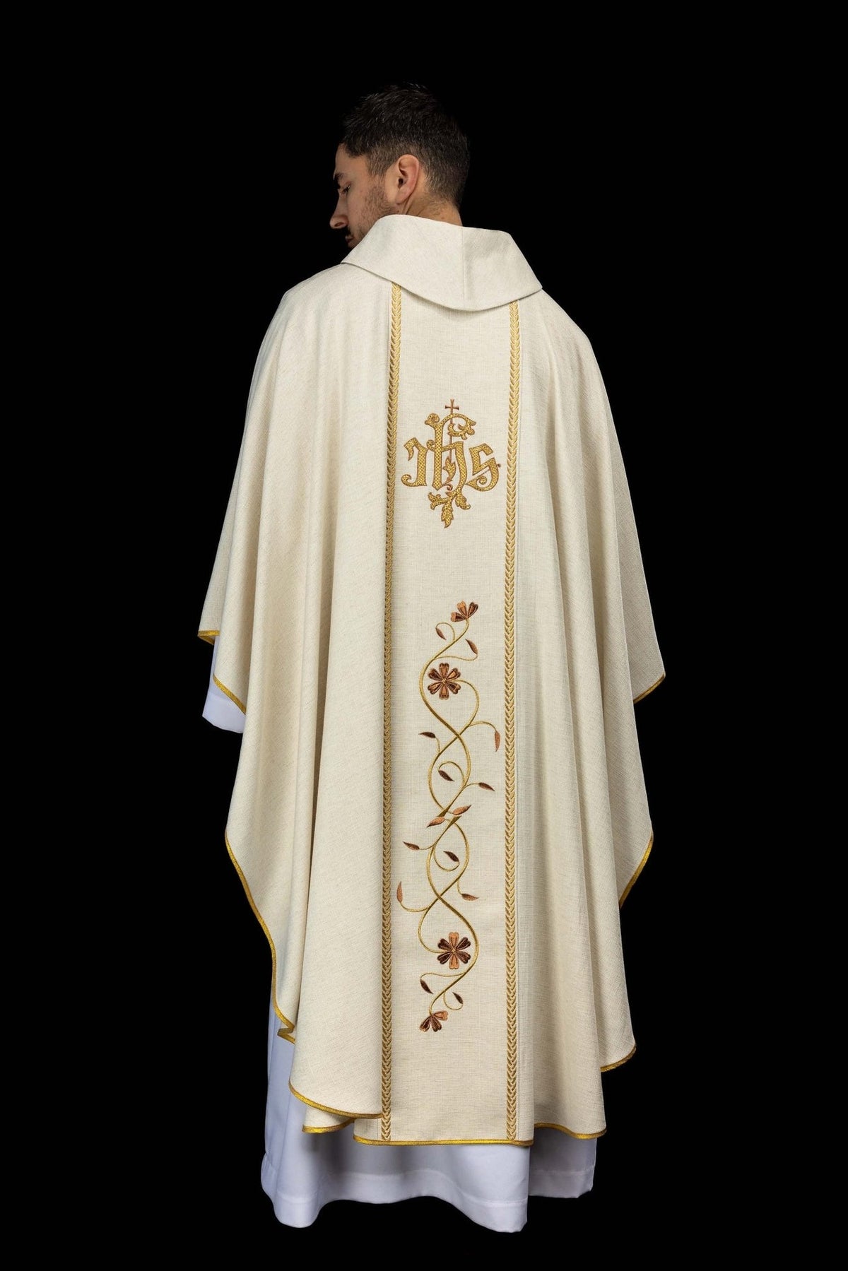 Ecru chasuble back close-up showing embroidered gold IHS monogram