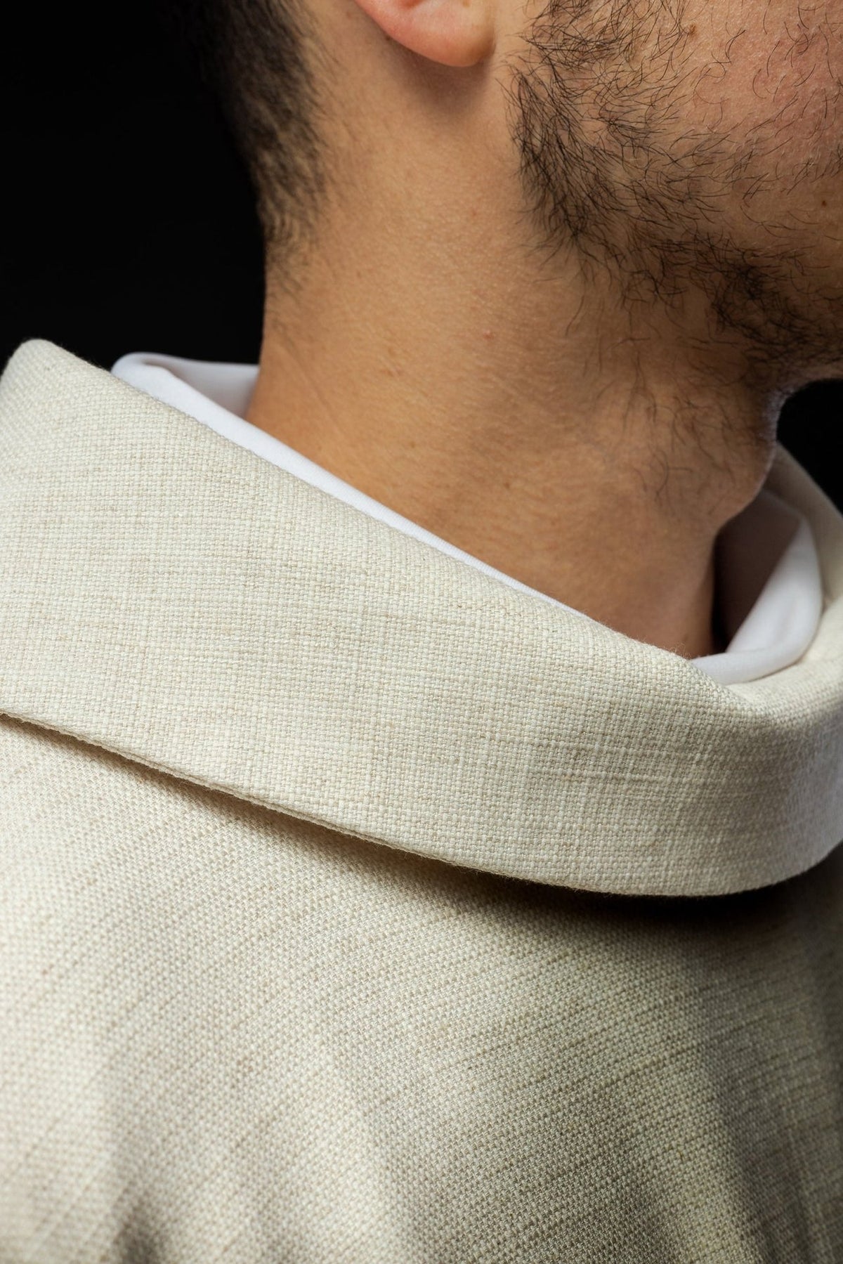Ecru chasuble close-up of gold trim and woven fabric