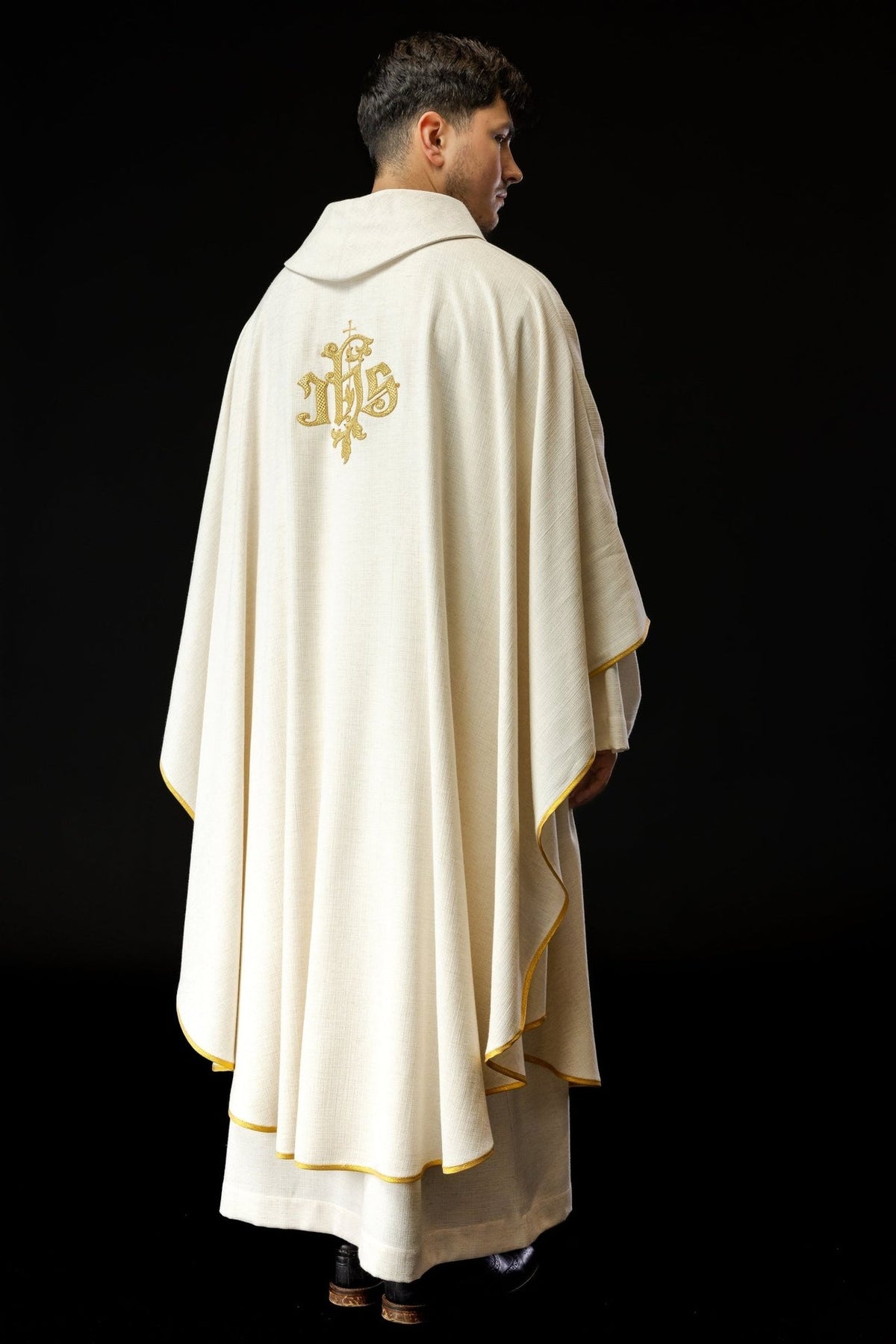 Saint Francis chasuble back close-up showing the gold embroidered IHS emblem