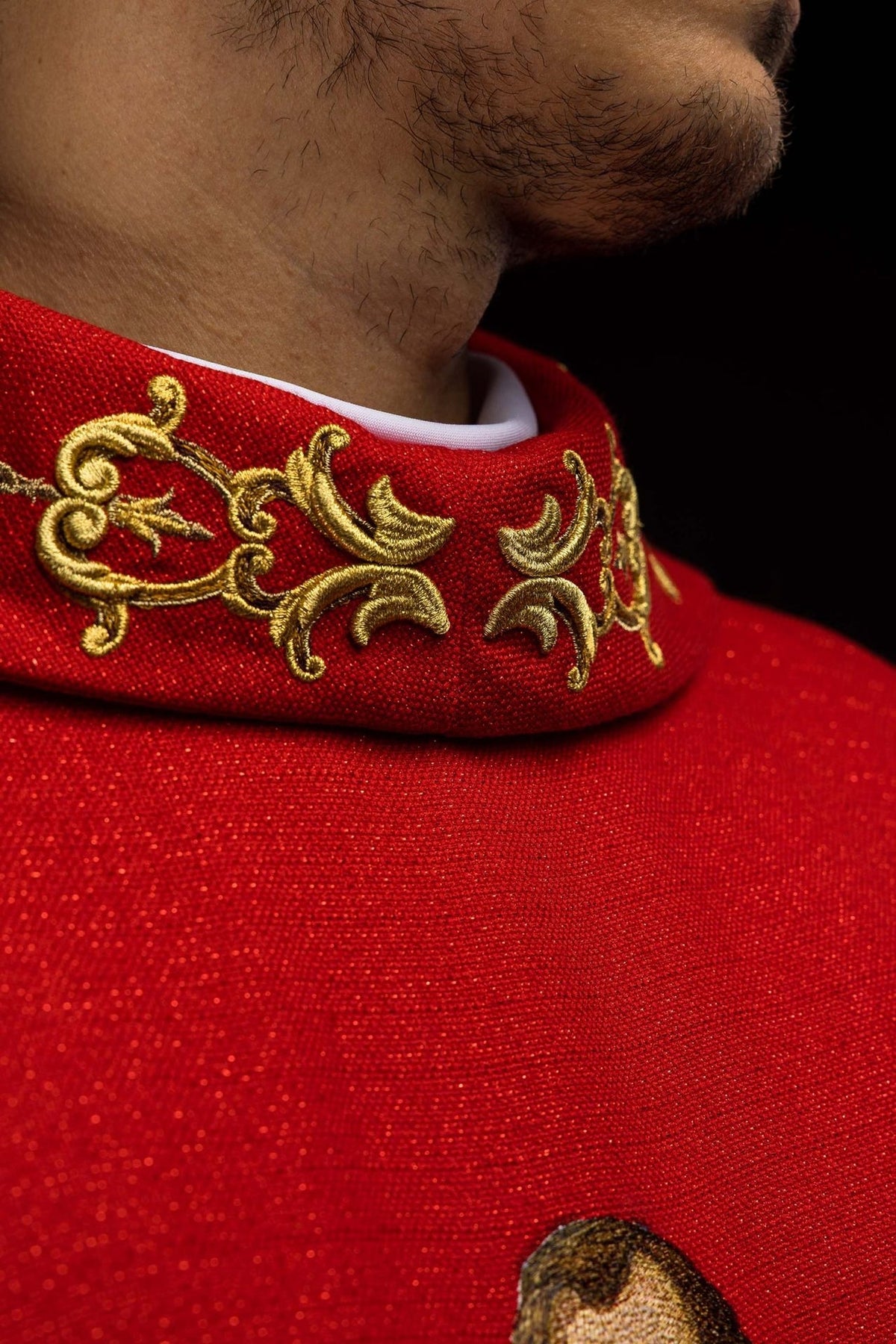 Red chasuble close-up showing gold stand-up collar embroidery