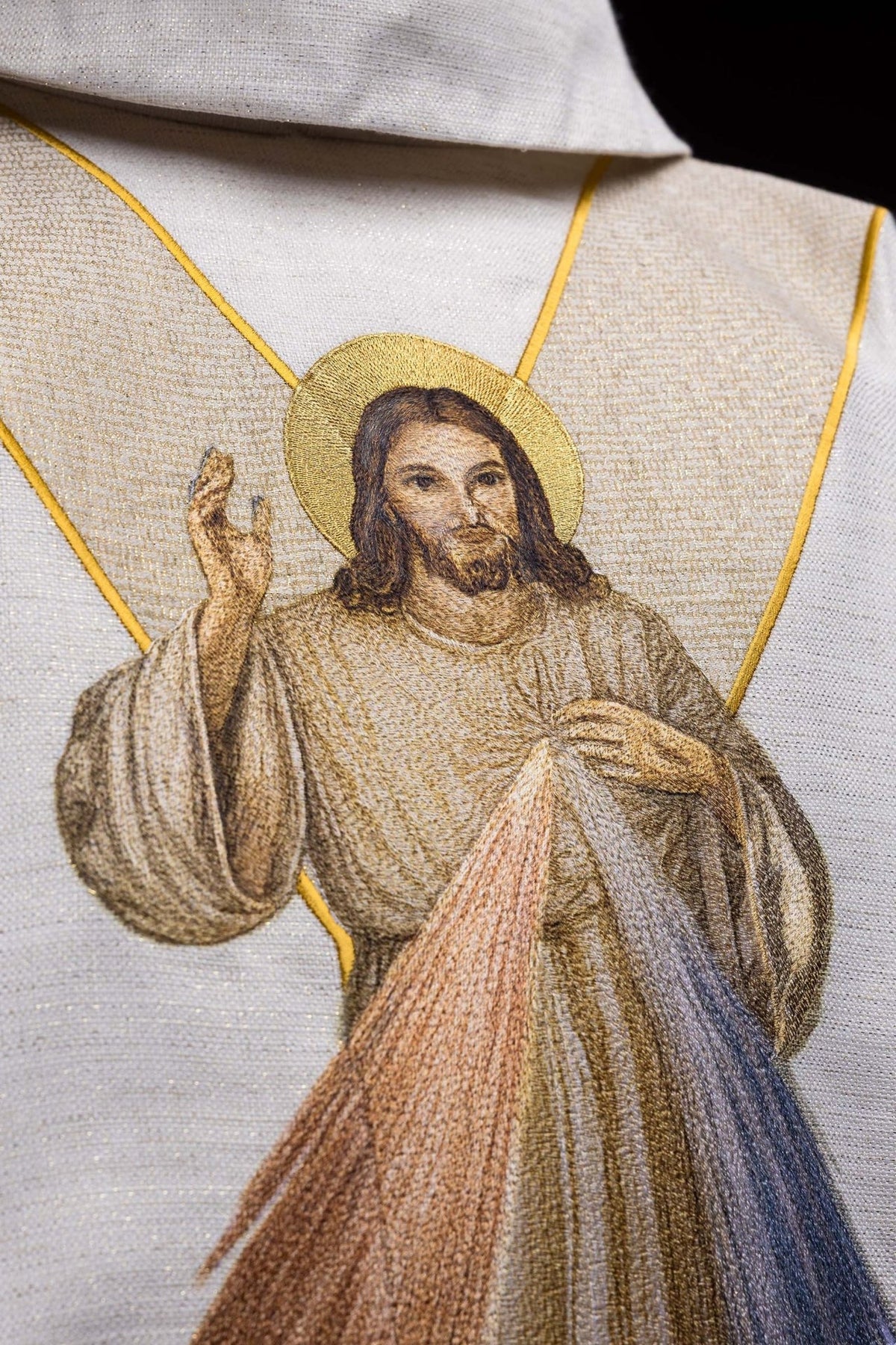 Close-up of embroidered Divine Mercy image on ecru chasuble
