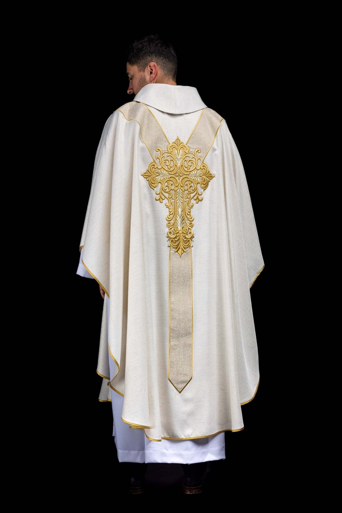 Back view of ecru chasuble with large gold embroidered cross and orphrey