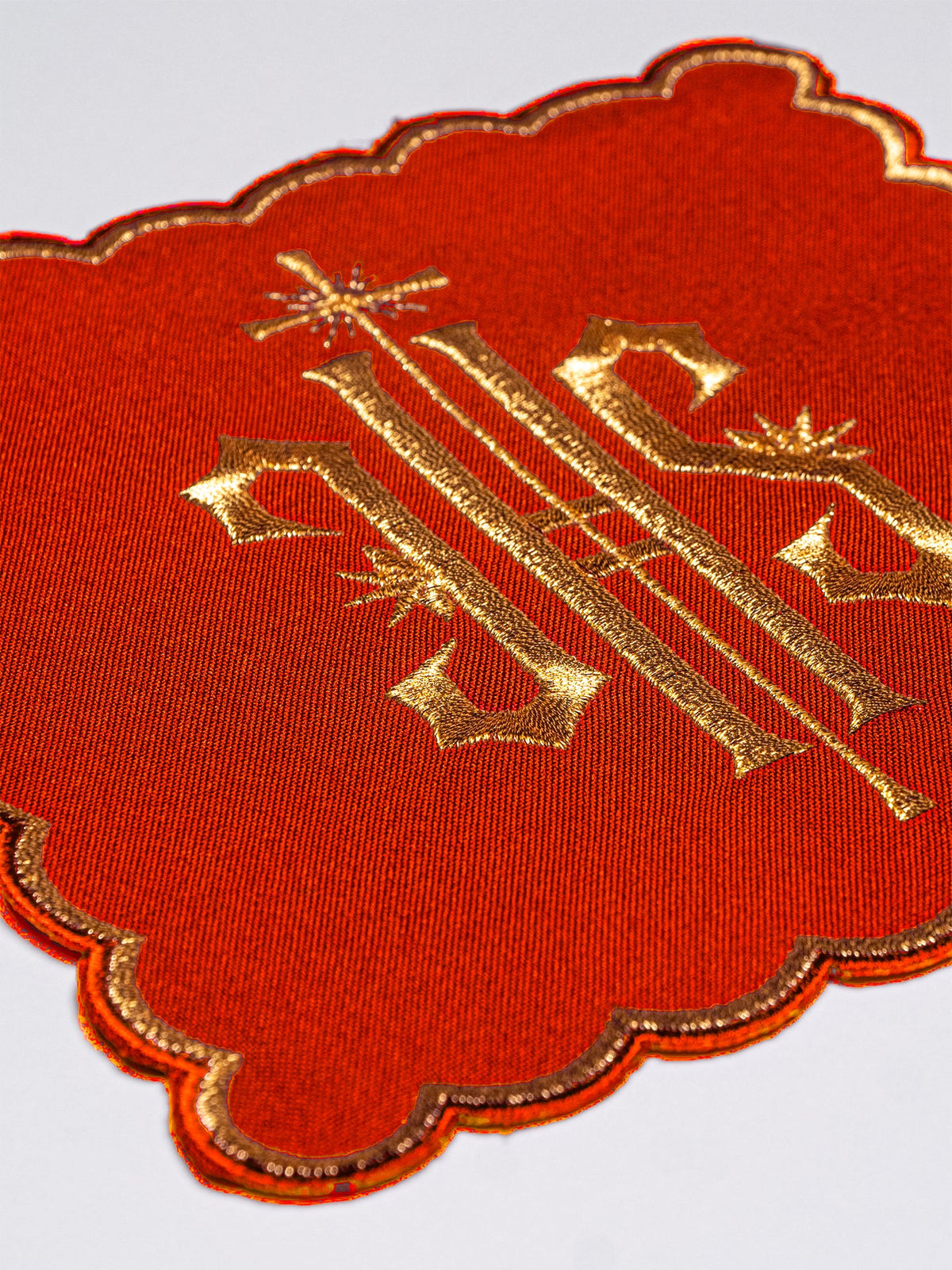 Red chalice pall with gold embroidered IHS symbol and scalloped gold edging