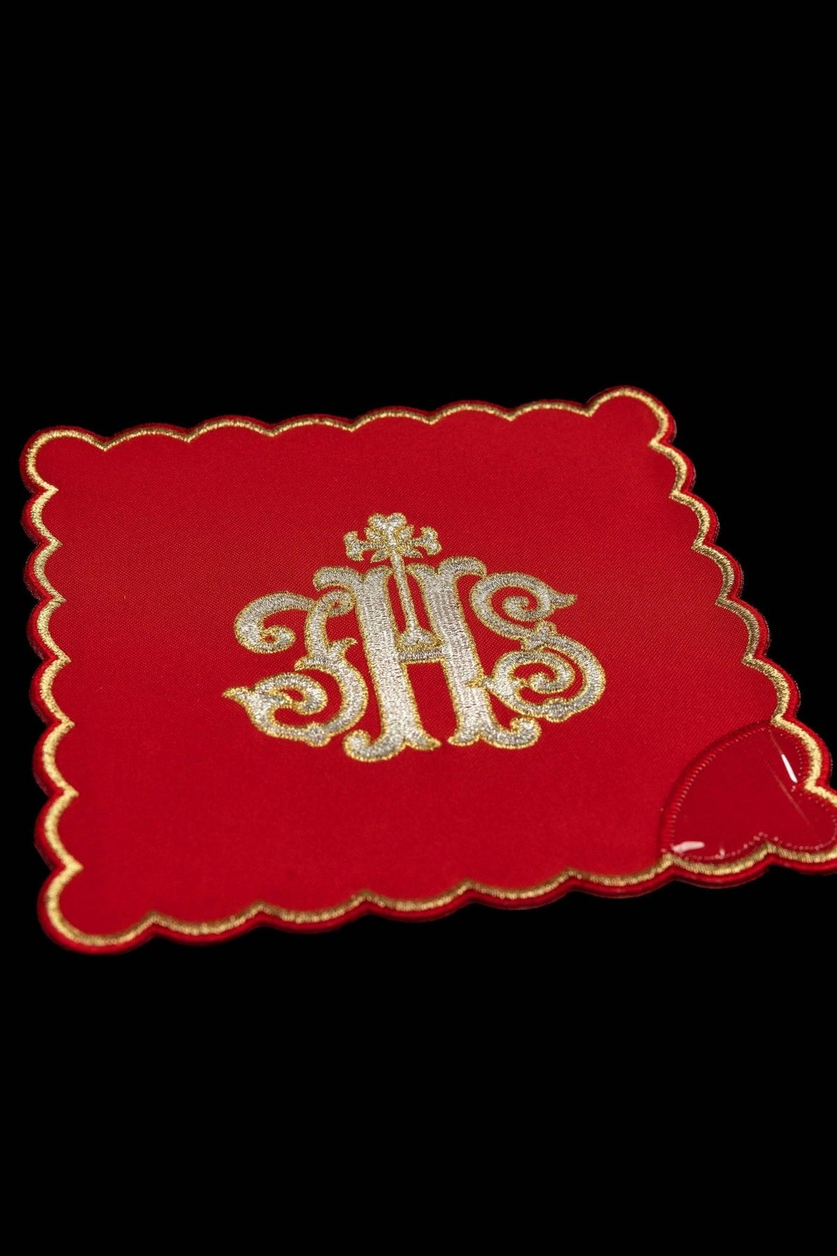 Red chalice pall with embroidered IHS monogram and gold scalloped border