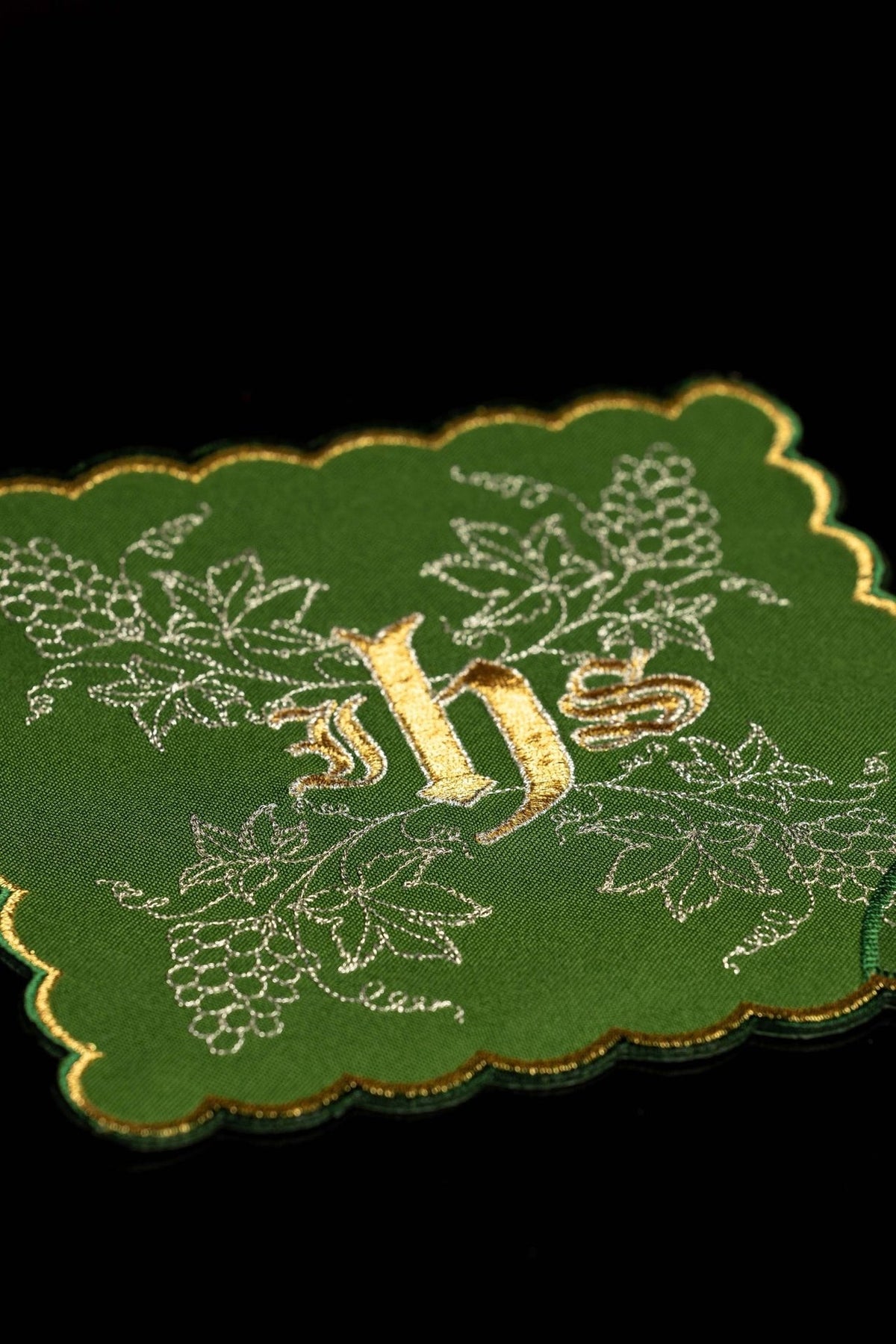 Green chalice pall close-up with gold IHS and embroidered grapes and vine