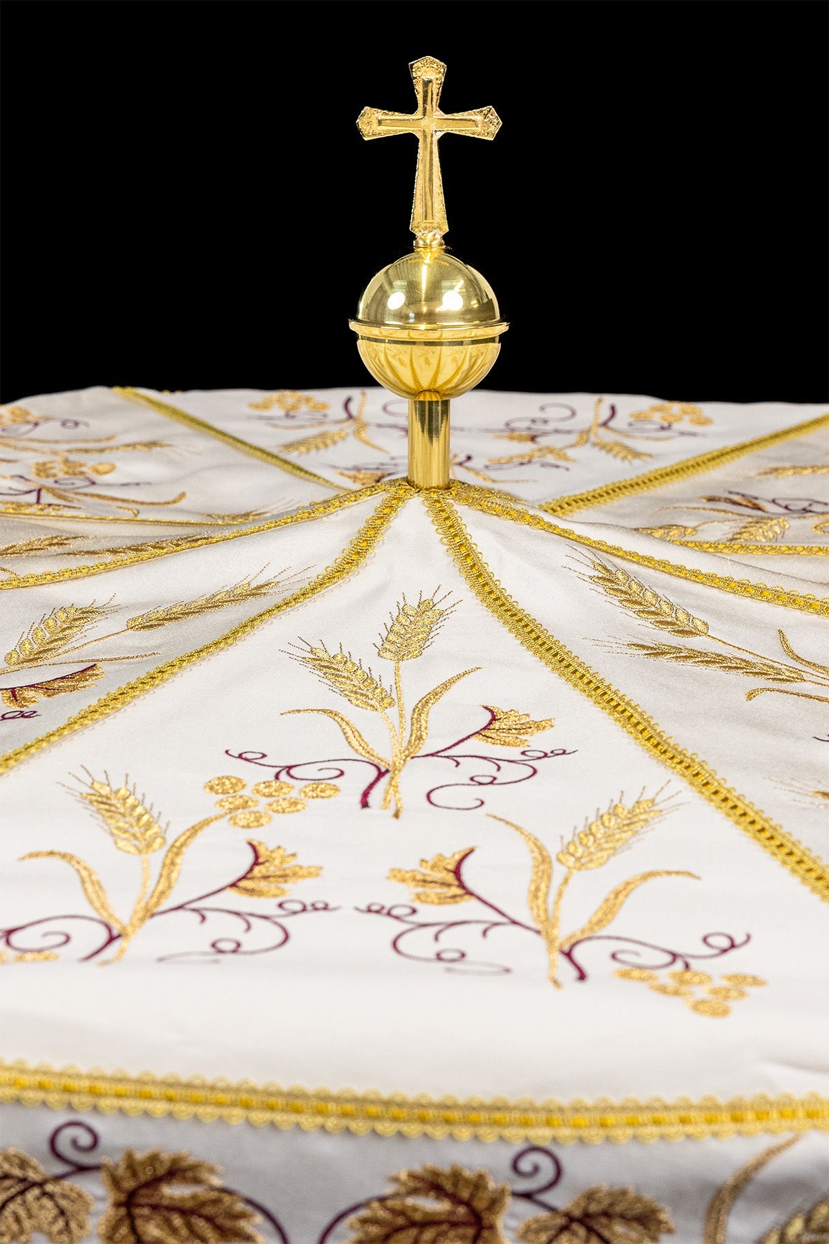 Ecru processional umbrella close-up with gold cross finial and wheat embroidery