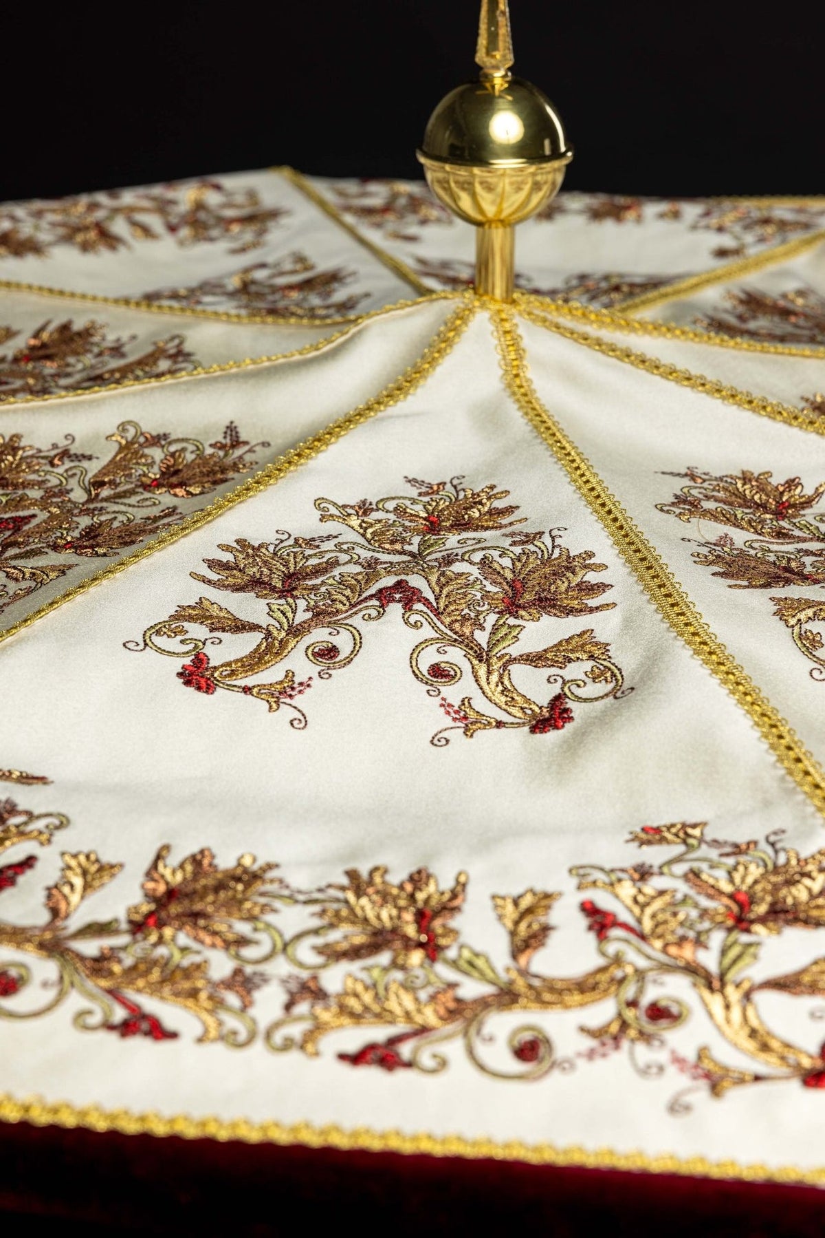 Processional umbrella detail of floral embroidery on an ecru canopy panel