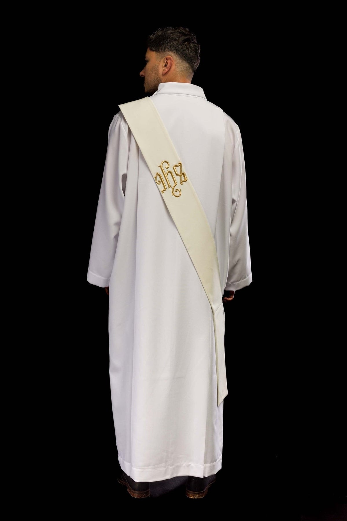 IHS deacon stole detail showing the plain ivory fabric and folded end