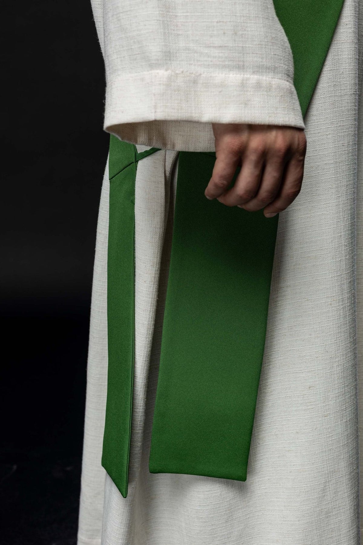 Green deacon stole close-up showing its plain reverse side and pointed end