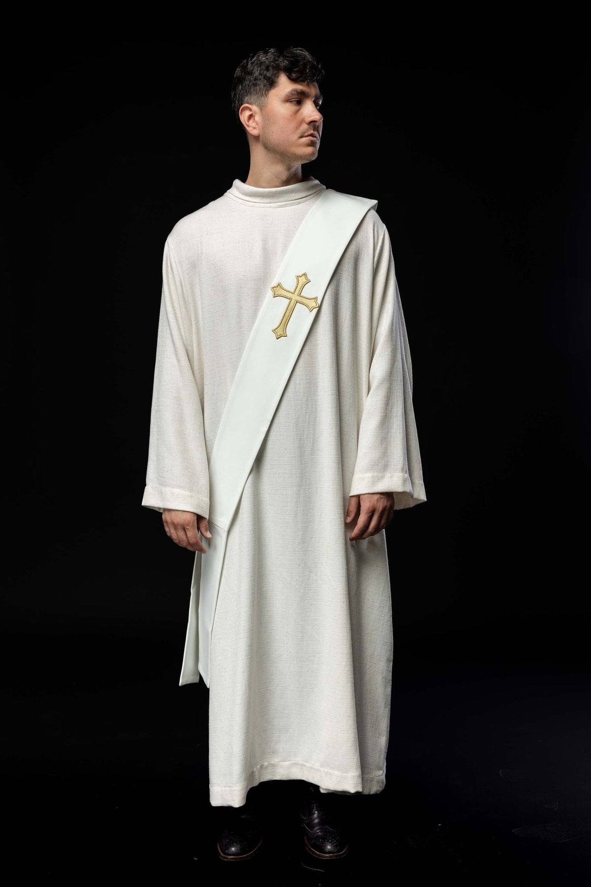 White deacon stole worn in a full front view with a gold embroidered cross
